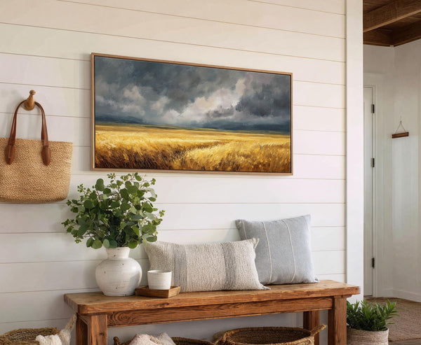 This horizontal canvas print features an impressionistic landscape of a golden field under a dramatic, cloudy sky, rendered in a palette of warm yellows and cool grays. It is displayed.