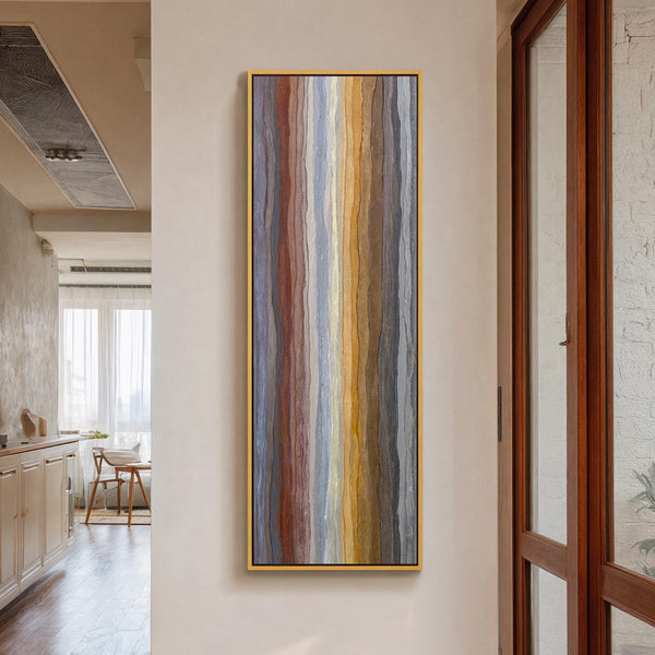 Vertical canvas wall art in interior setting.