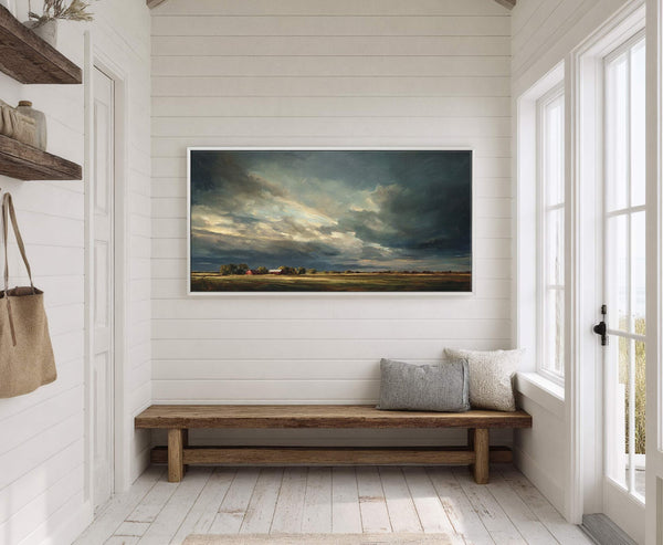This horizontal canvas wall art showcases a dramatic, impressionistic landscape with a stormy sky over a field and red barns, set against white wood-paneled walls in a room with a.