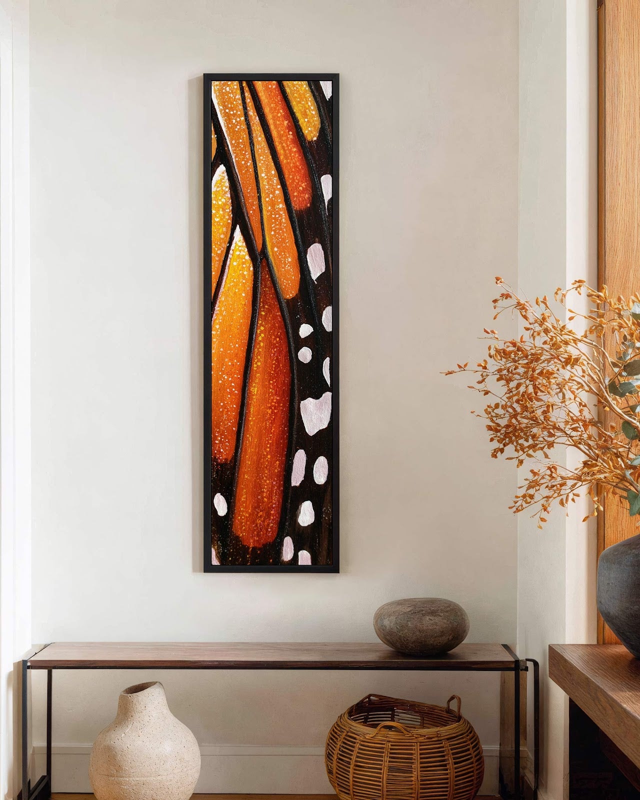 Vertical canvas wall art in interior setting.