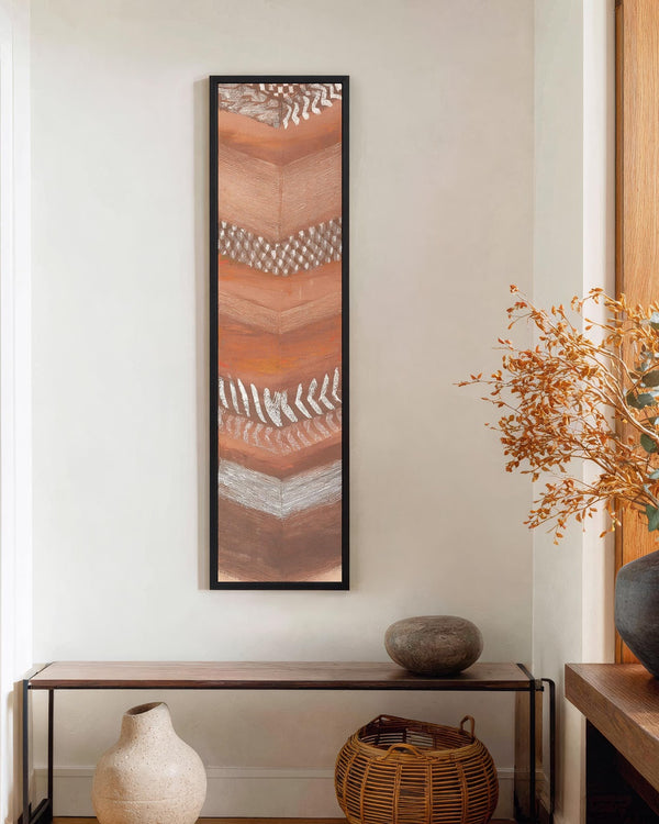 Vertical canvas wall art in interior setting.