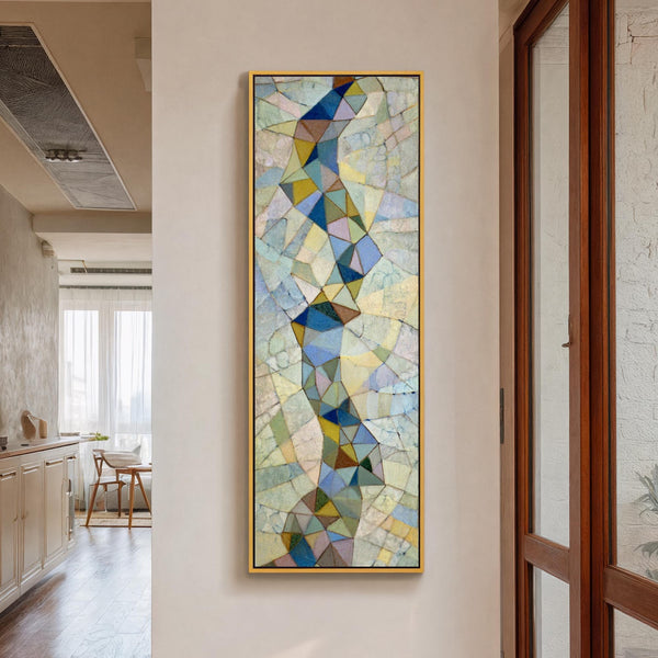 Vertical canvas wall art in interior setting.