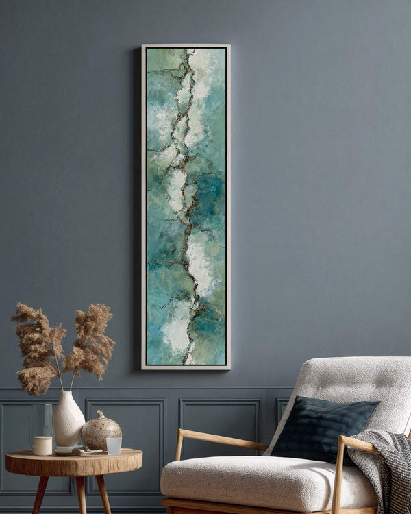 Vertical canvas wall art in interior setting.