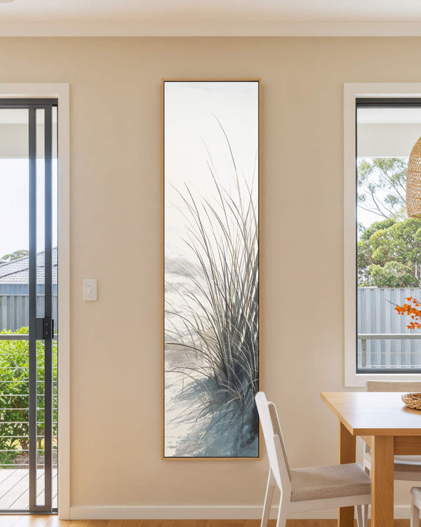 Vertical canvas wall art in interior setting.