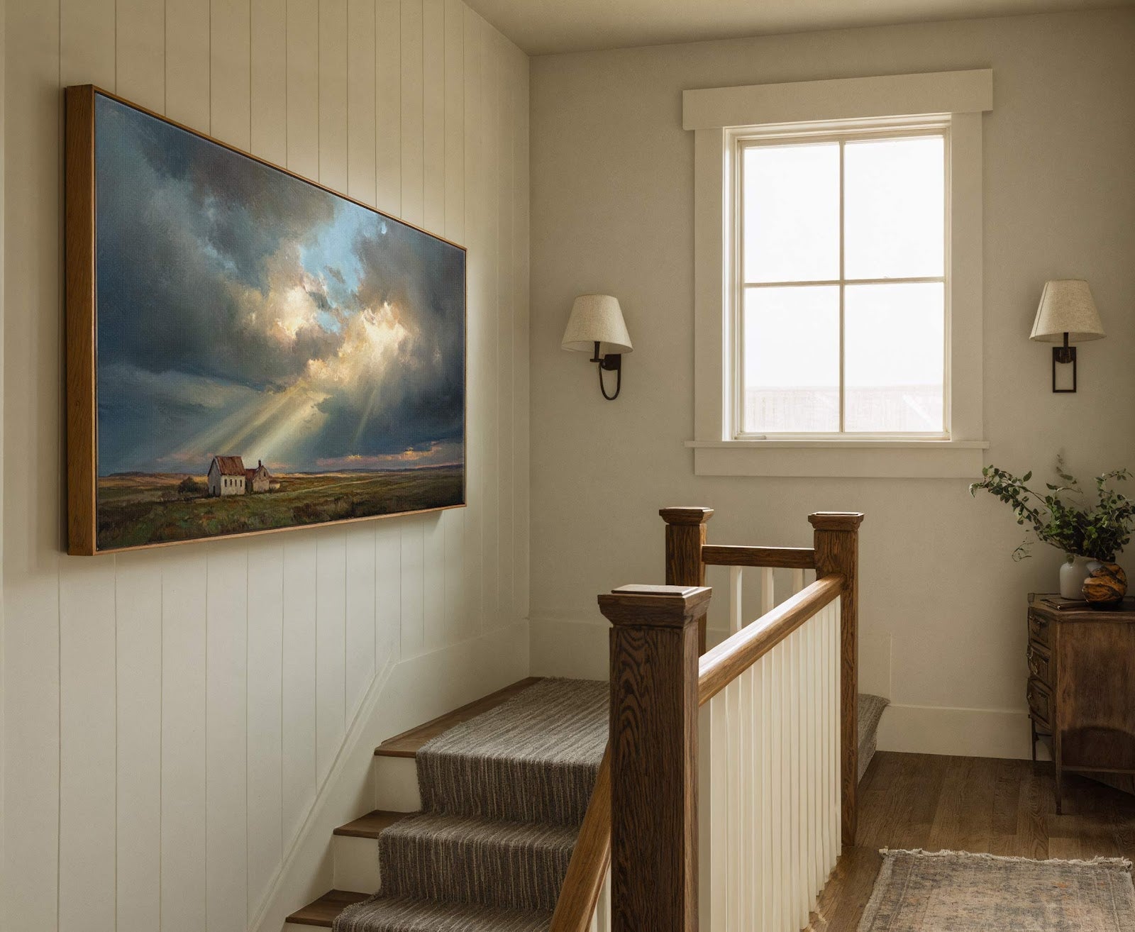 This horizontal canvas wall art features a dramatic, expressionist landscape painting with a rustic farmhouse under stormy, light-streaked skies, displayed on a white paneled wall in a hallway with a.