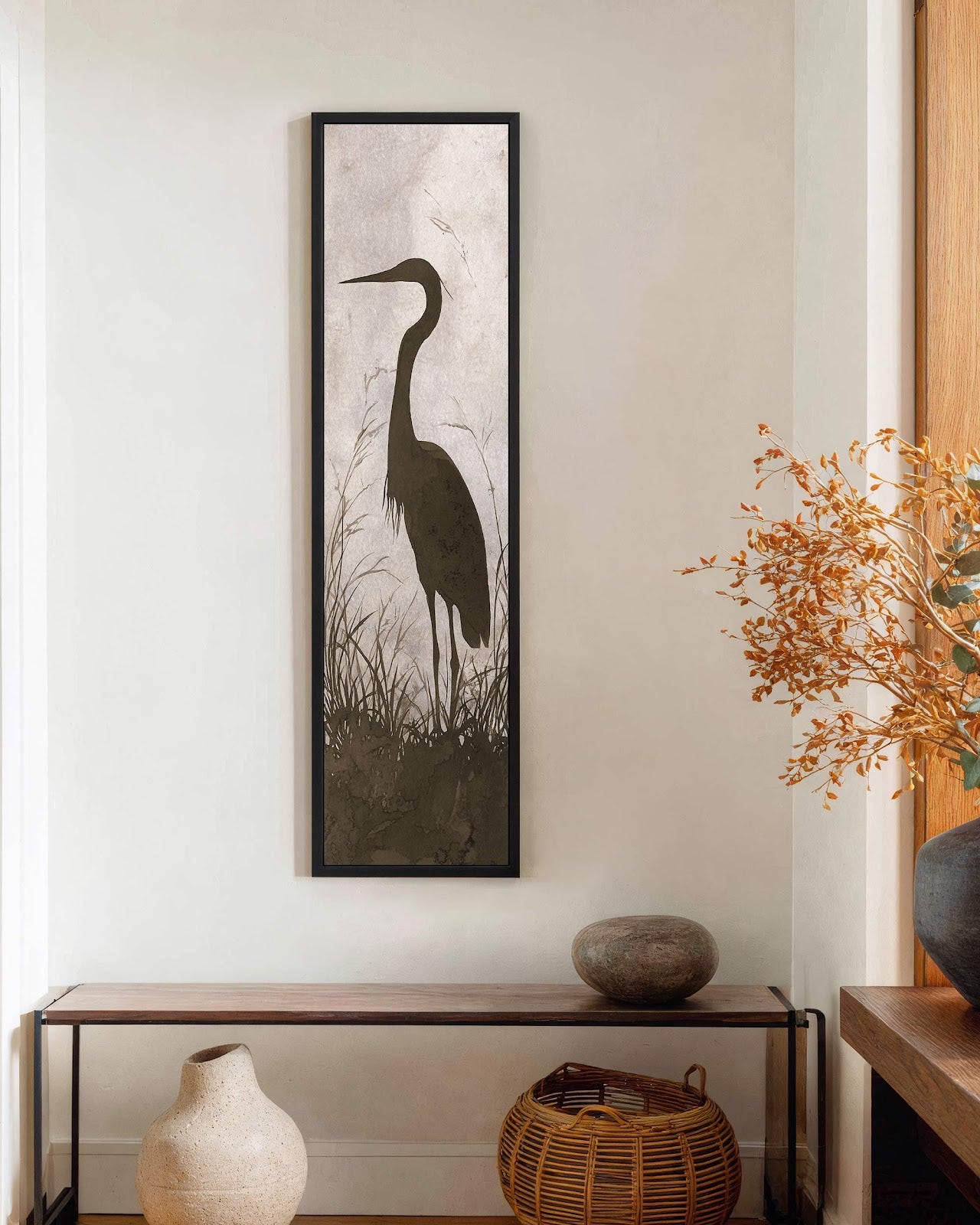 Vertical canvas wall art in interior setting.