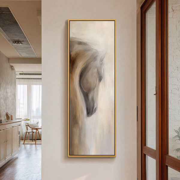 This vertical, abstract art print features a horse head rendered in a soft, muted palette of beige, brown, and gray, displayed in a thin gold frame against a light-colored wall.