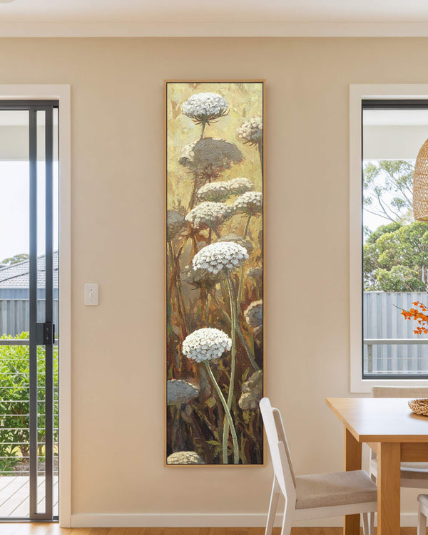 Vertical canvas wall art in interior setting.