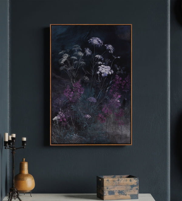 Pecan framed dark botanical art print featuring delicate white and vibrant purple wildflowers amidst deep green foliage against a moody, deep blue and black background, hung on a charcoal wall