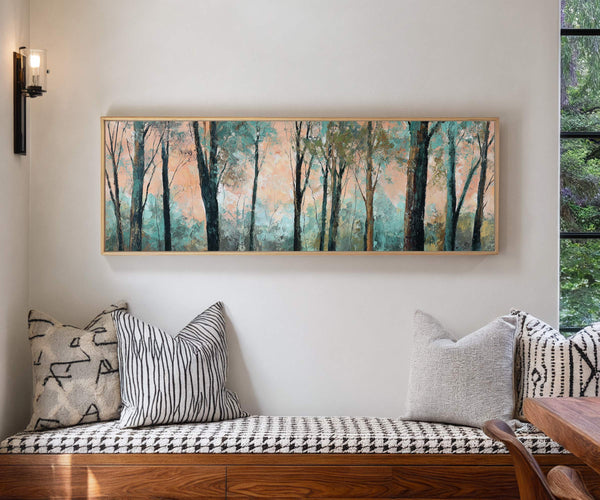 Whispering Grove forest landscape canvas wall art framed above a modern bench with patterned cushions in a cozy contemporary interior