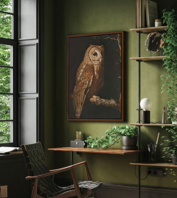 Green home office interior with a prominent owl painting, wooden desk, plant-filled shelves, and a dark woven armchair by a large window