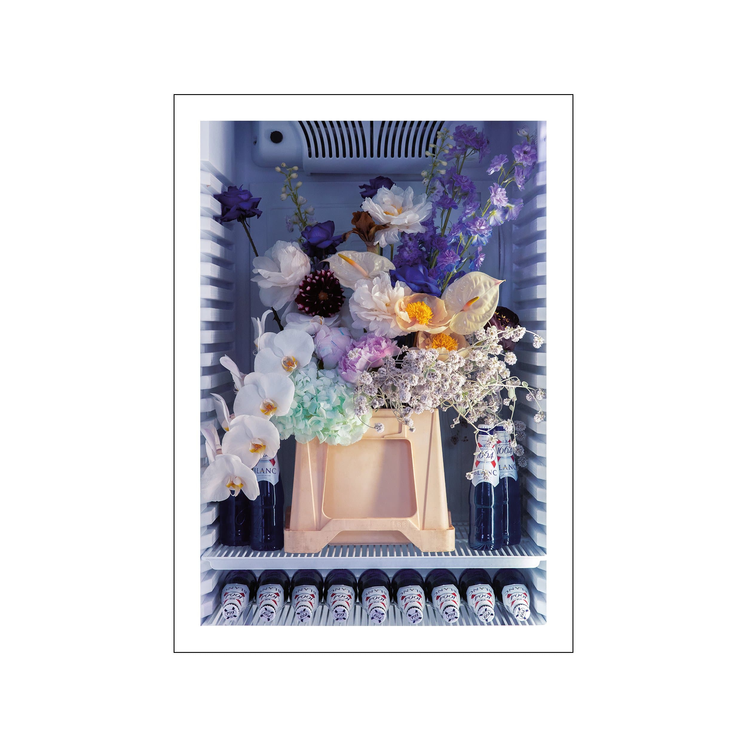 Blue refrigerator filled with flowers, wine bottles, and a peach crate in a still life composition