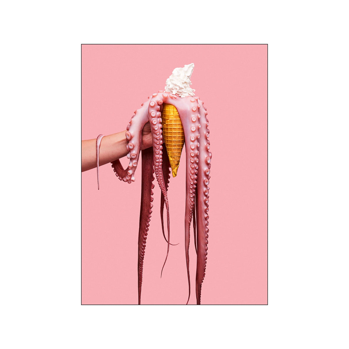 Pink octopus tentacles draped over a golden ice cream cone on a soft pink background
