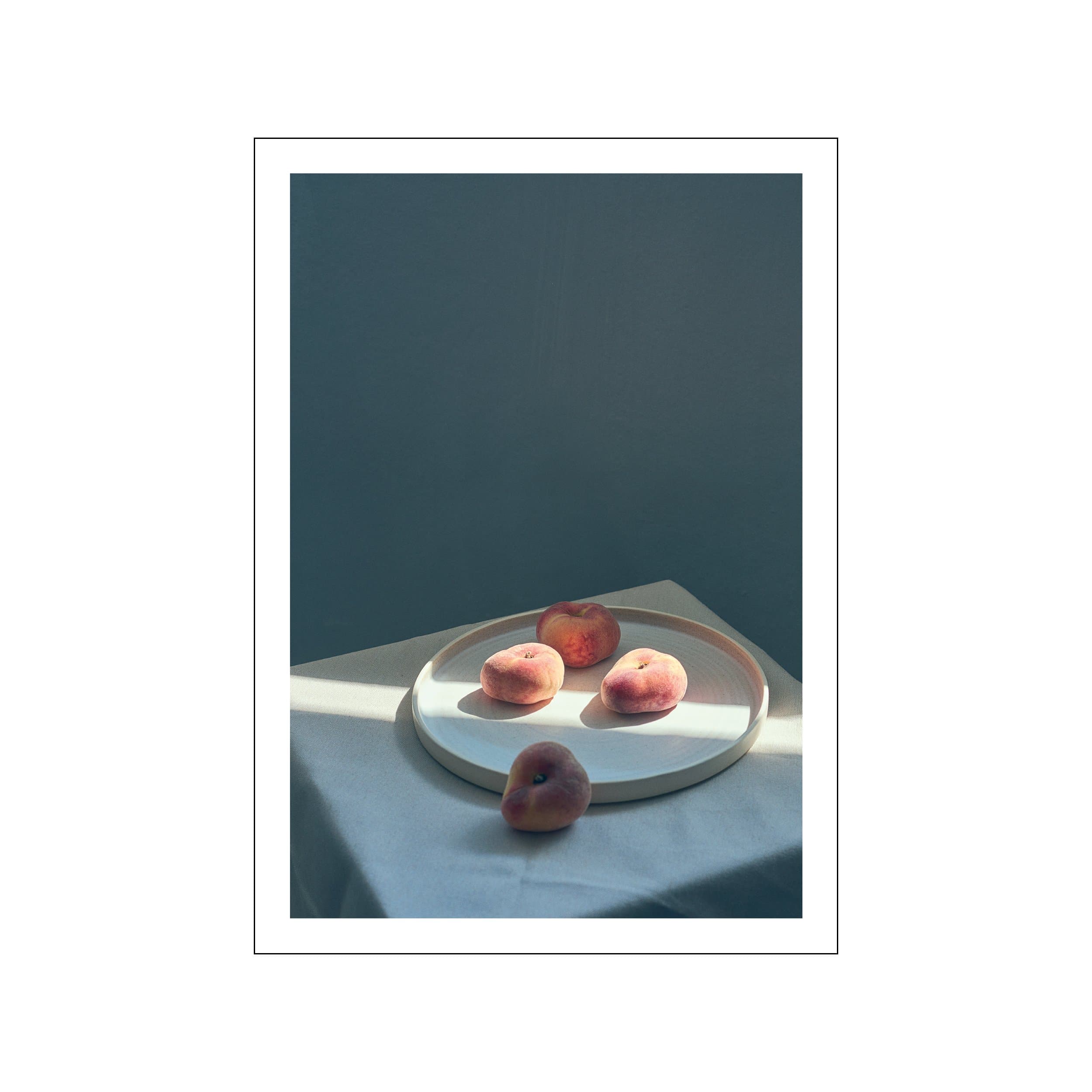 Still life print of four peaches on a pale ceramic plate against a deep blue backdrop