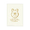A sketch of Winnie the Pooh's face in warm gold tones on a creamy background, with 'Winnie the Pooh' written in charming script and floral accents. Evokes nostalgia and gentle whimsy.