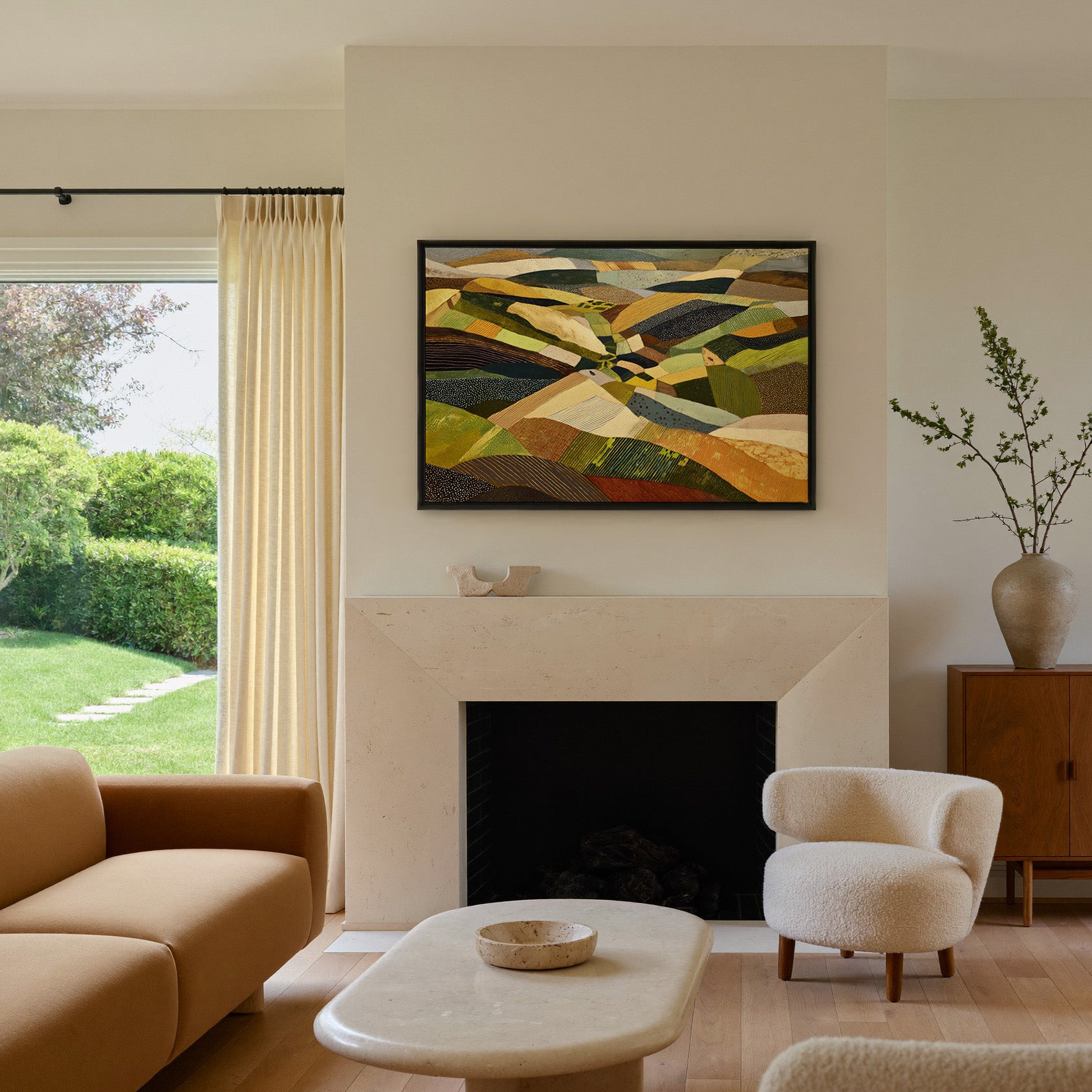rolling abstract aerial landscape in olive, canvas wall art in a black frame above a mantel