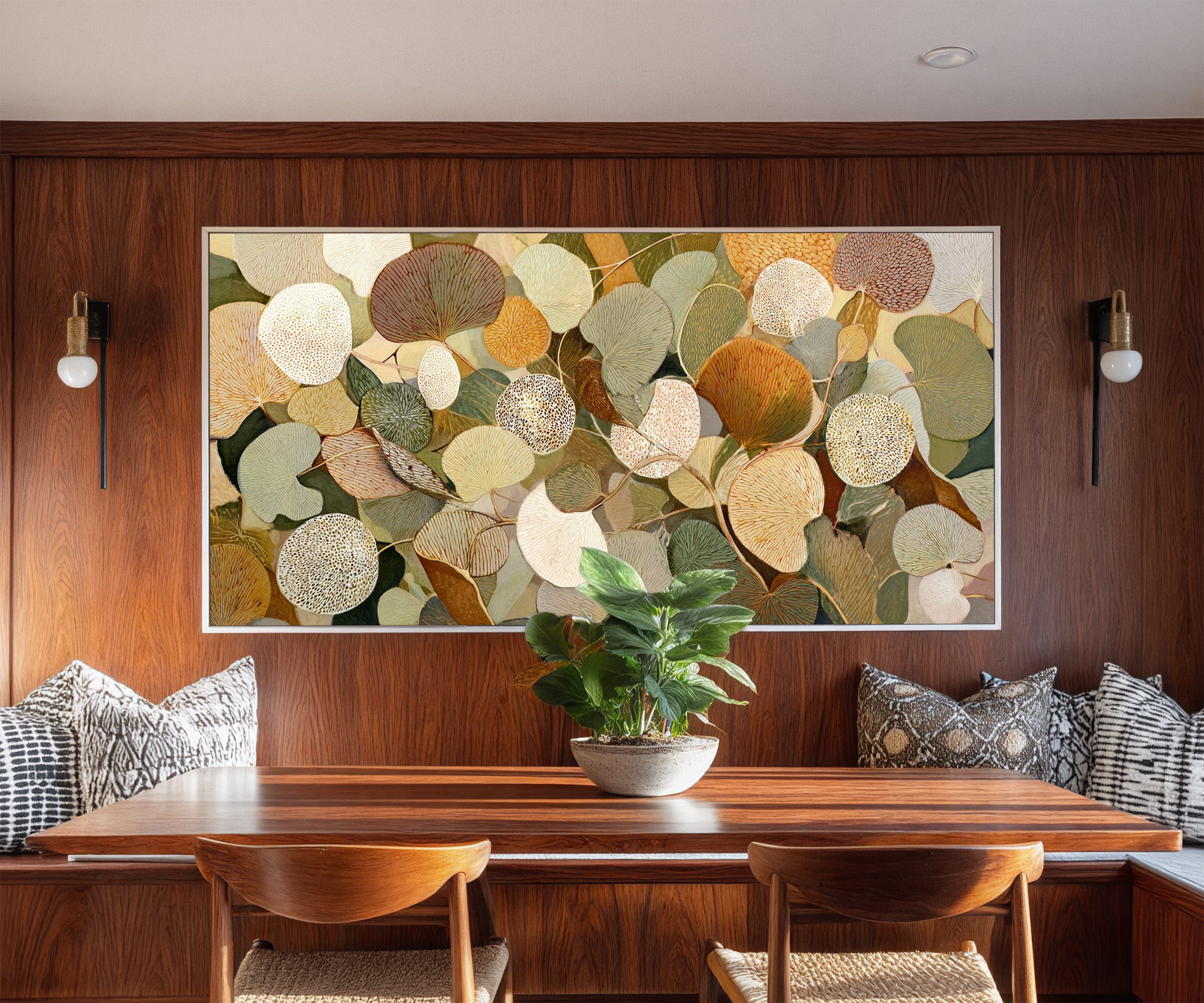 rounded leaf forms in olive, cream, gold, rust, canvas wall art in a white frame in a styled room setting