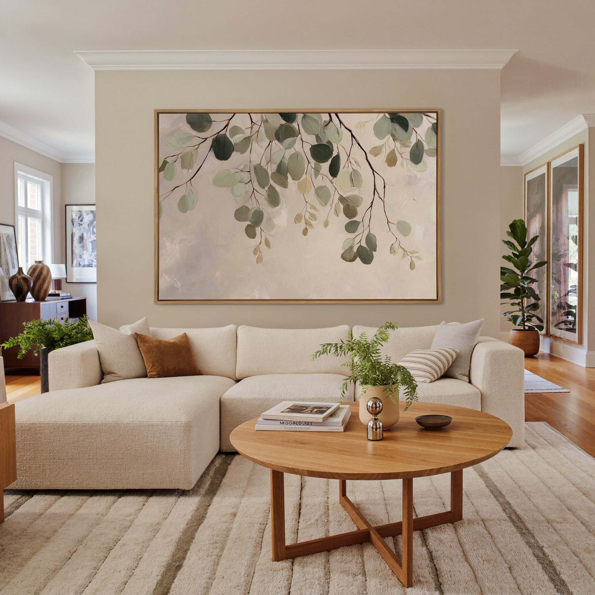 airy eucalyptus leaves on pale ground canvas wall art in an oak frame in a living room