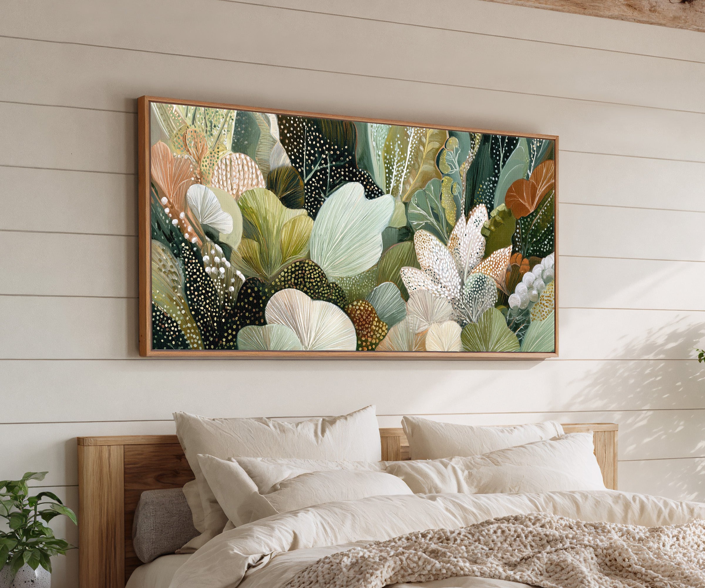 dense forest inspired botanical abstract in canvas wall art in an oak frame above a bed