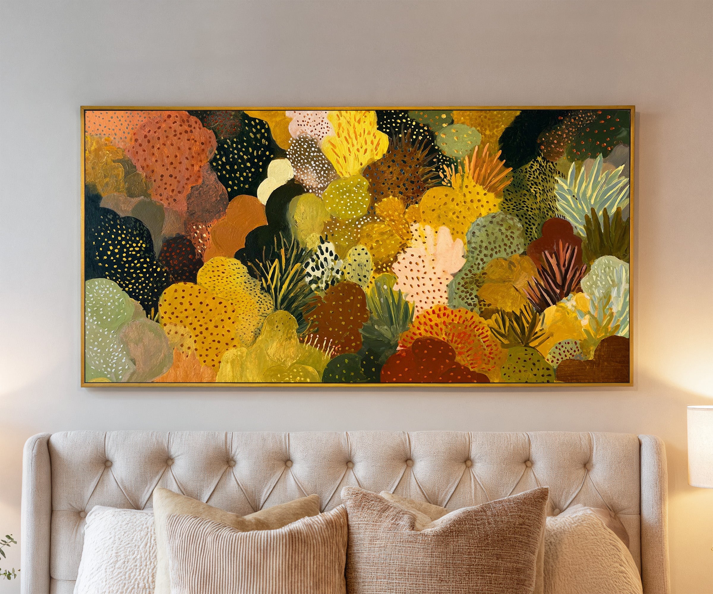 dense ochre and terracotta abstract canvas wall art in a gold frame above a bed