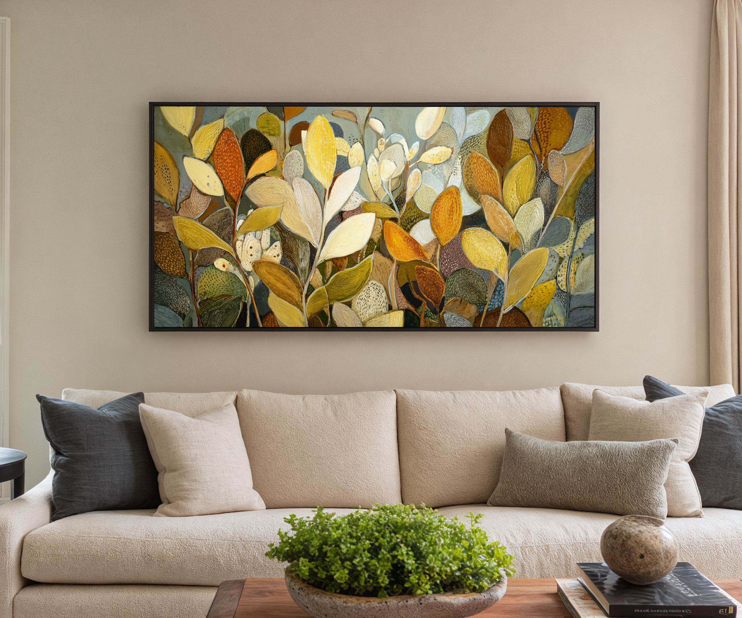 dense overlapping leaf forms in gold, cream, canvas wall art in a black frame in a styled room setting