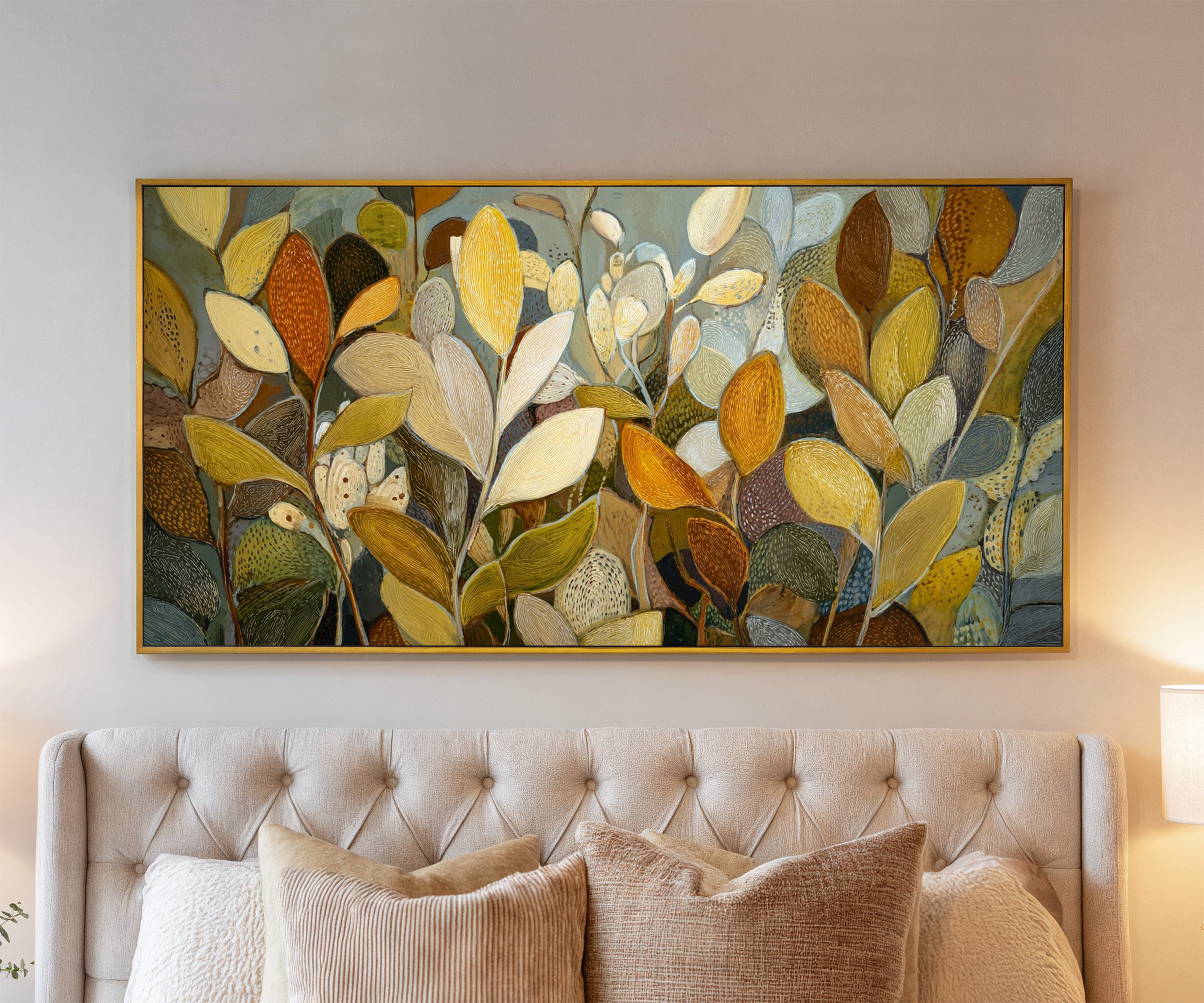 dense overlapping leaf forms in gold, cream, canvas wall art in a gold frame above a bed