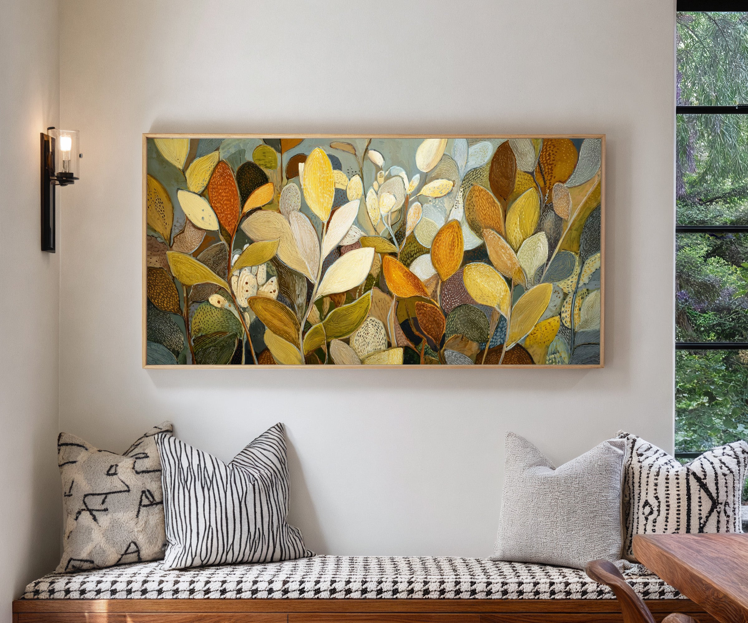 dense overlapping leaf forms in gold, cream, canvas wall art in a natural wood frame in a living room