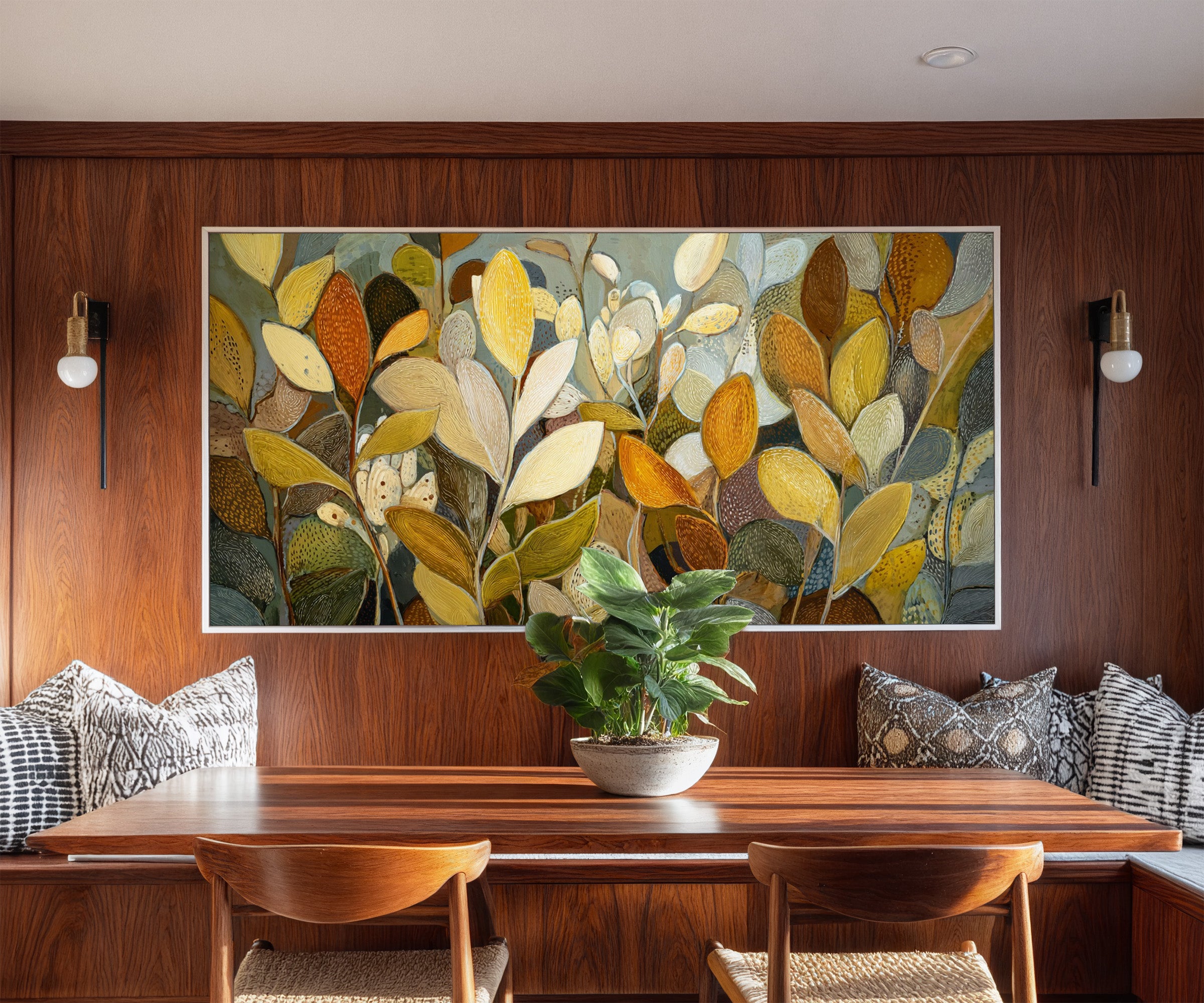 dense overlapping leaf forms in gold, cream, canvas wall art in a white frame in a styled room setting