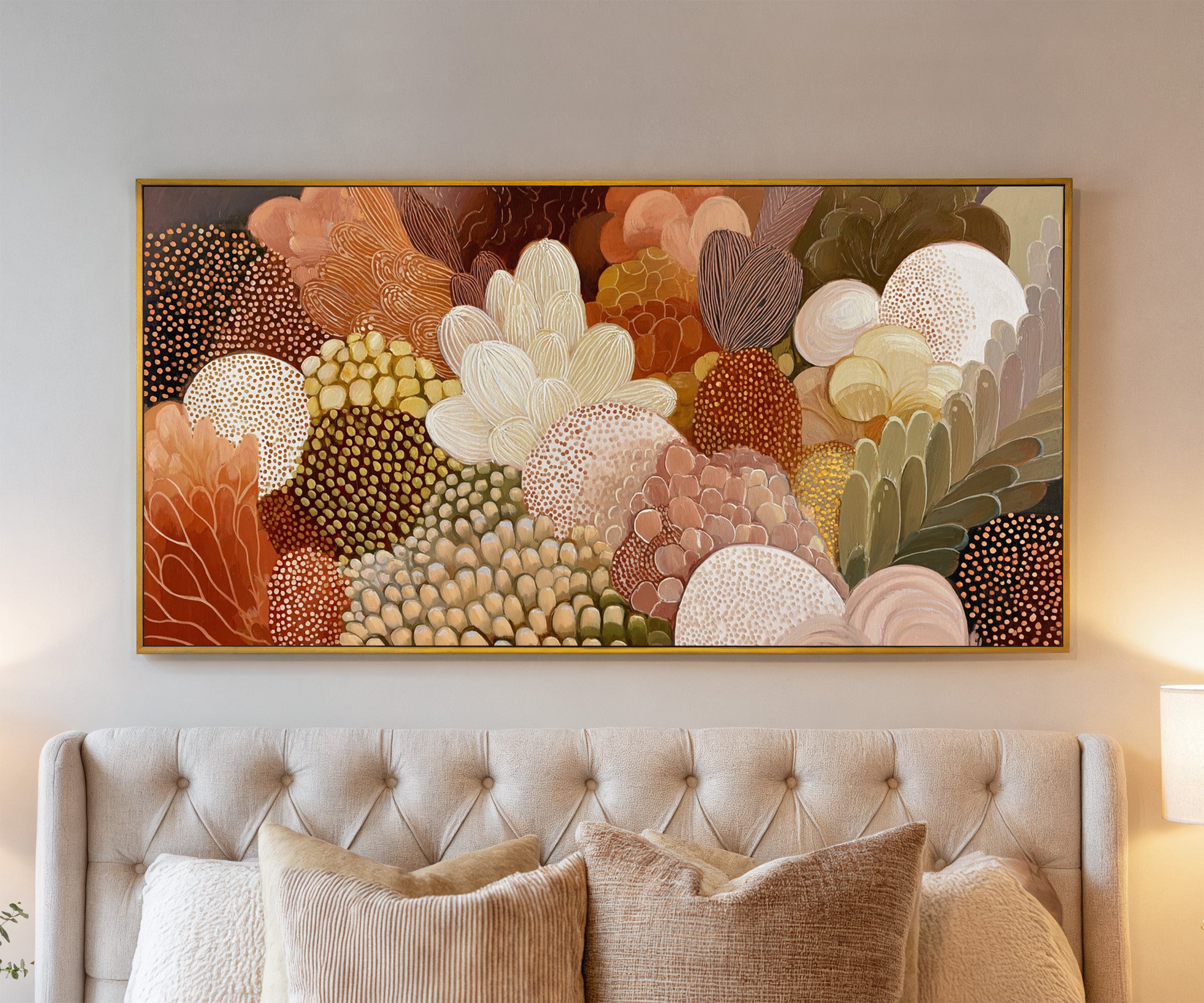 dense layered botanical forms in warm neutrals, canvas wall art in a gold frame above a bed