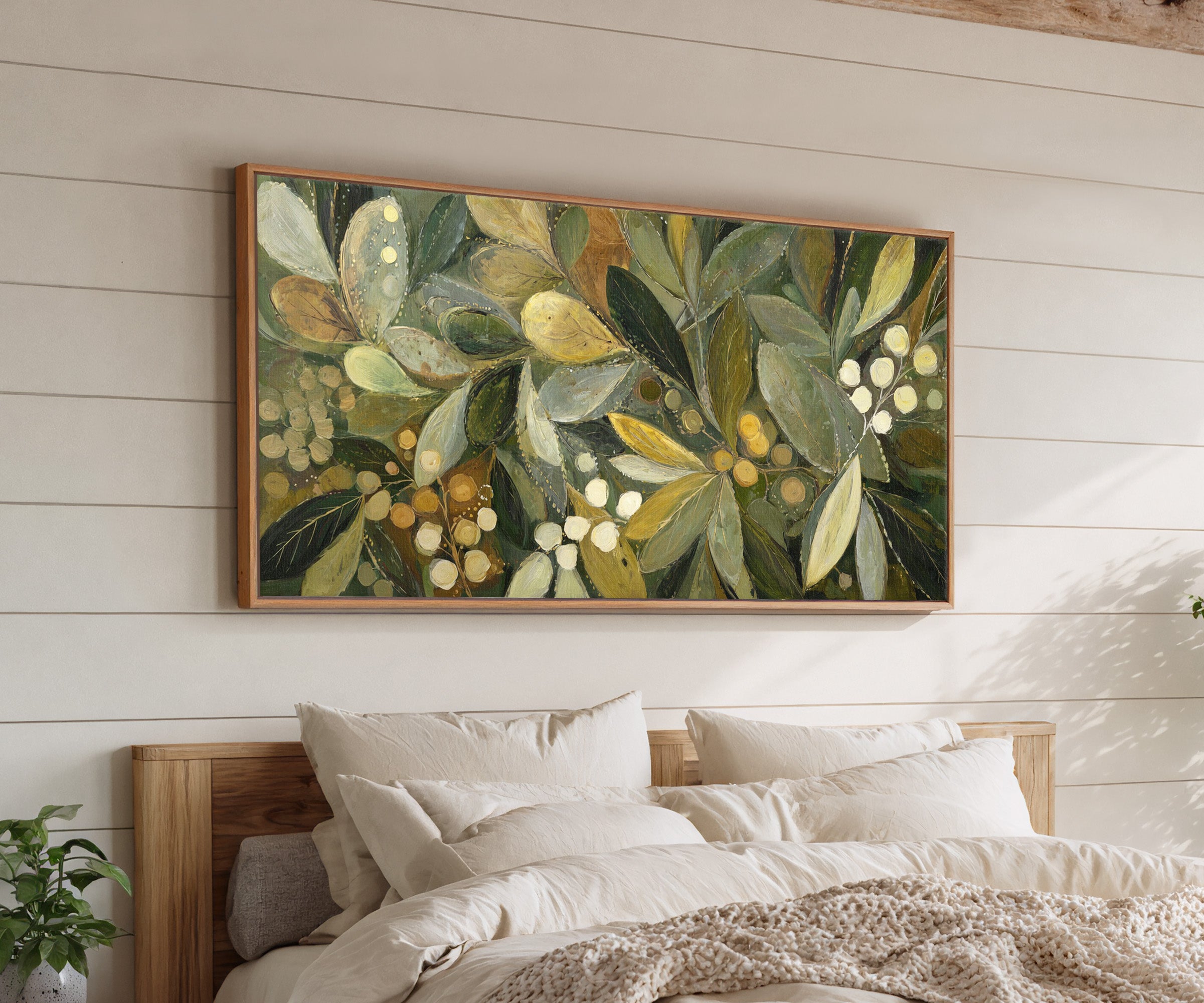 layered olive leaves with pale berries canvas wall art in an oak frame above a bed