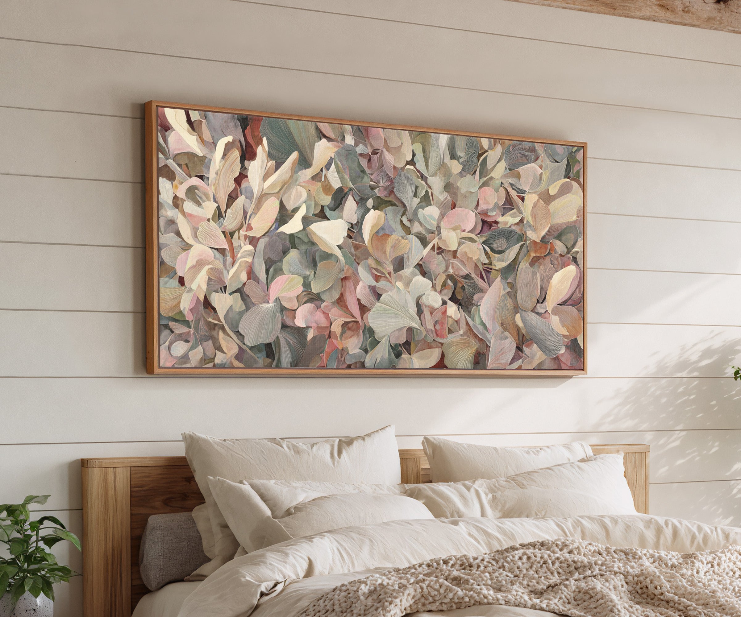 dense rounded petals in blush, cream, sage, and canvas wall art in an oak frame above a bed