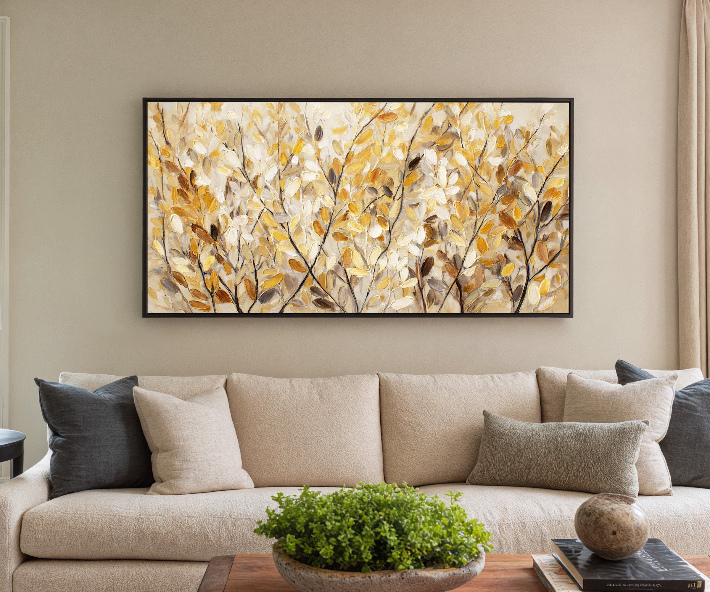 golden leaves and dark branching stems canvas wall art in a black frame in a styled room setting
