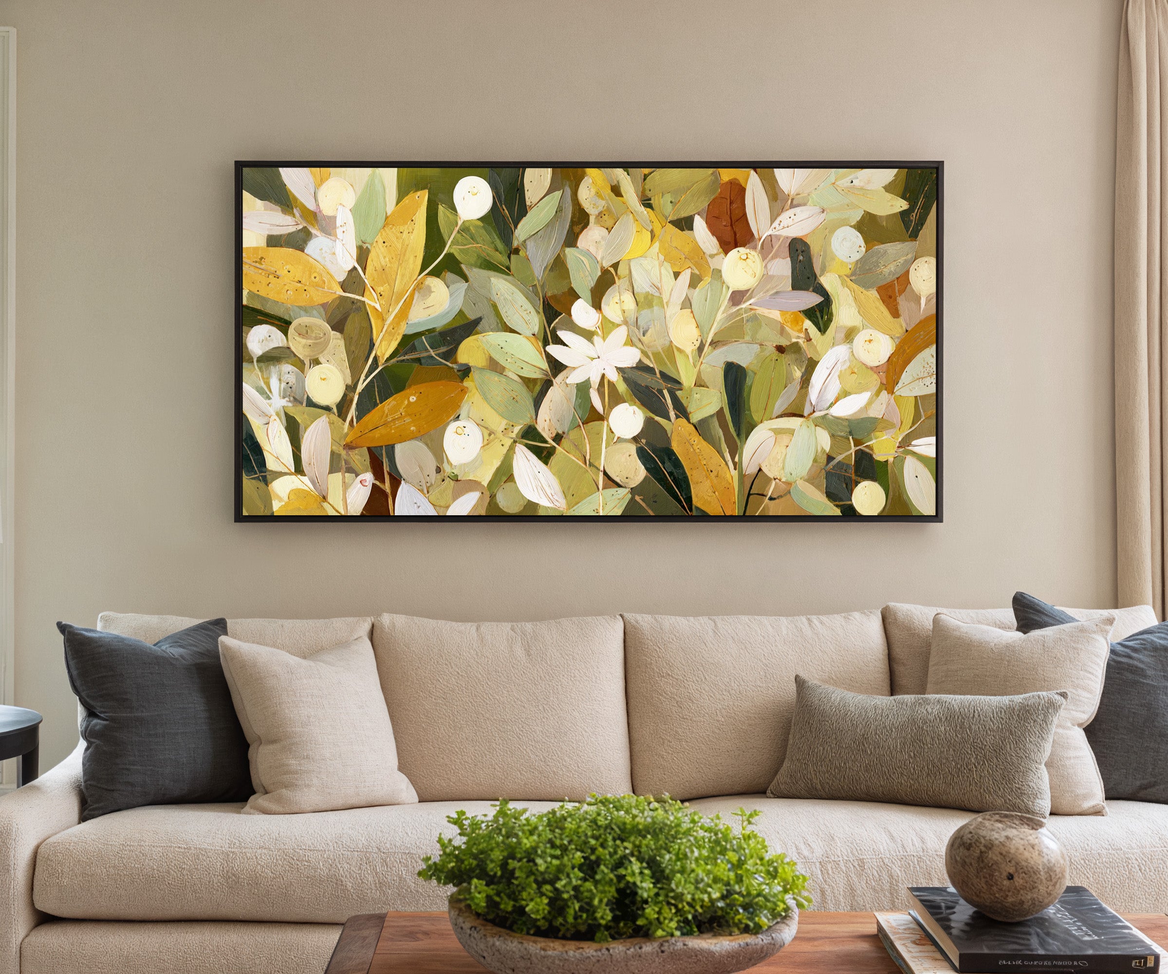 dense olive and gold leaf forms with pale canvas wall art in a black frame in a styled room setting