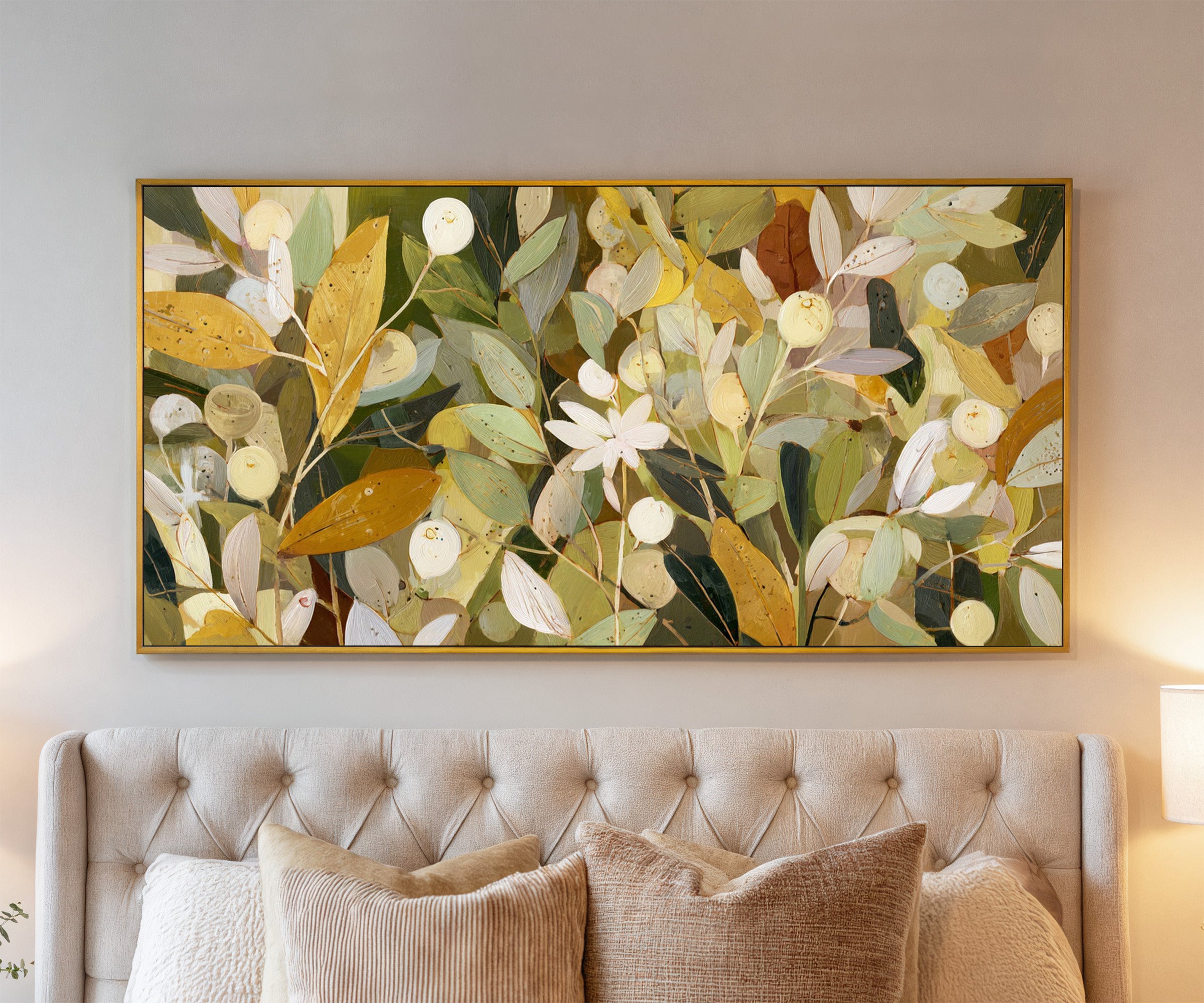 dense olive and gold leaf forms with pale canvas wall art in a gold frame above a bed