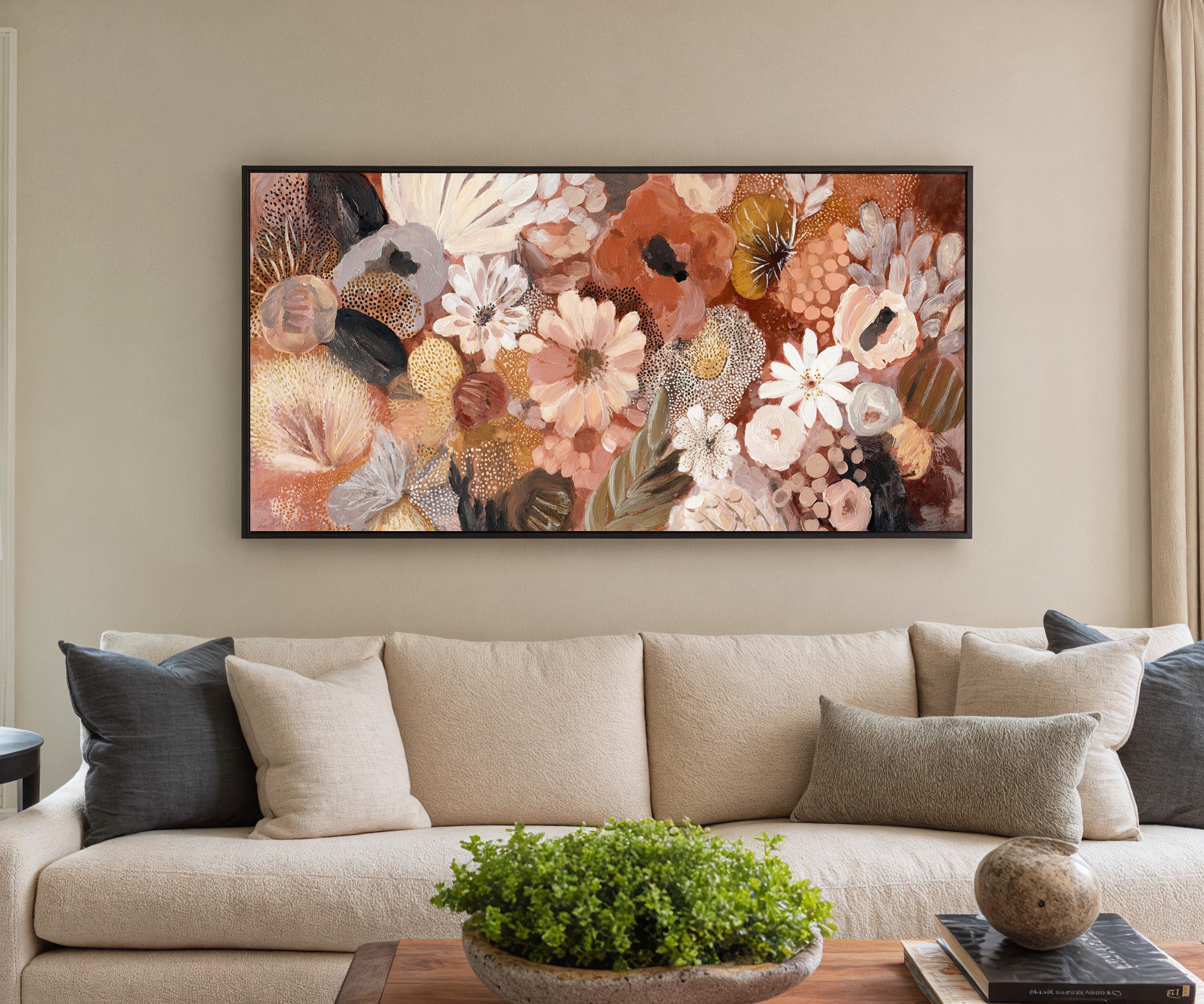 densely packed rounded florals in terracotta, canvas wall art in a black frame in a styled room setting