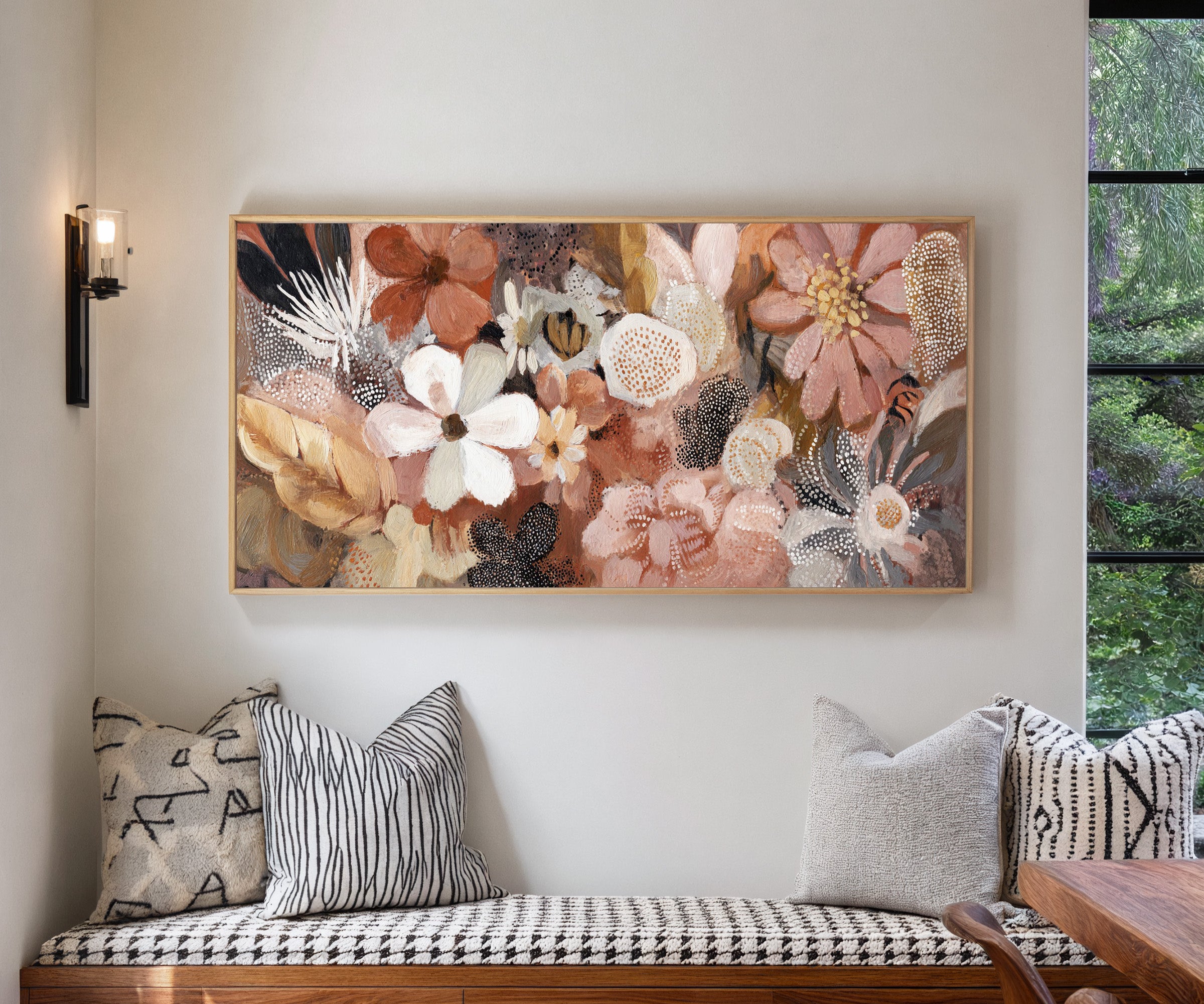 densely packed rounded flowers in blush, rust, canvas wall art in a natural wood frame in a living room