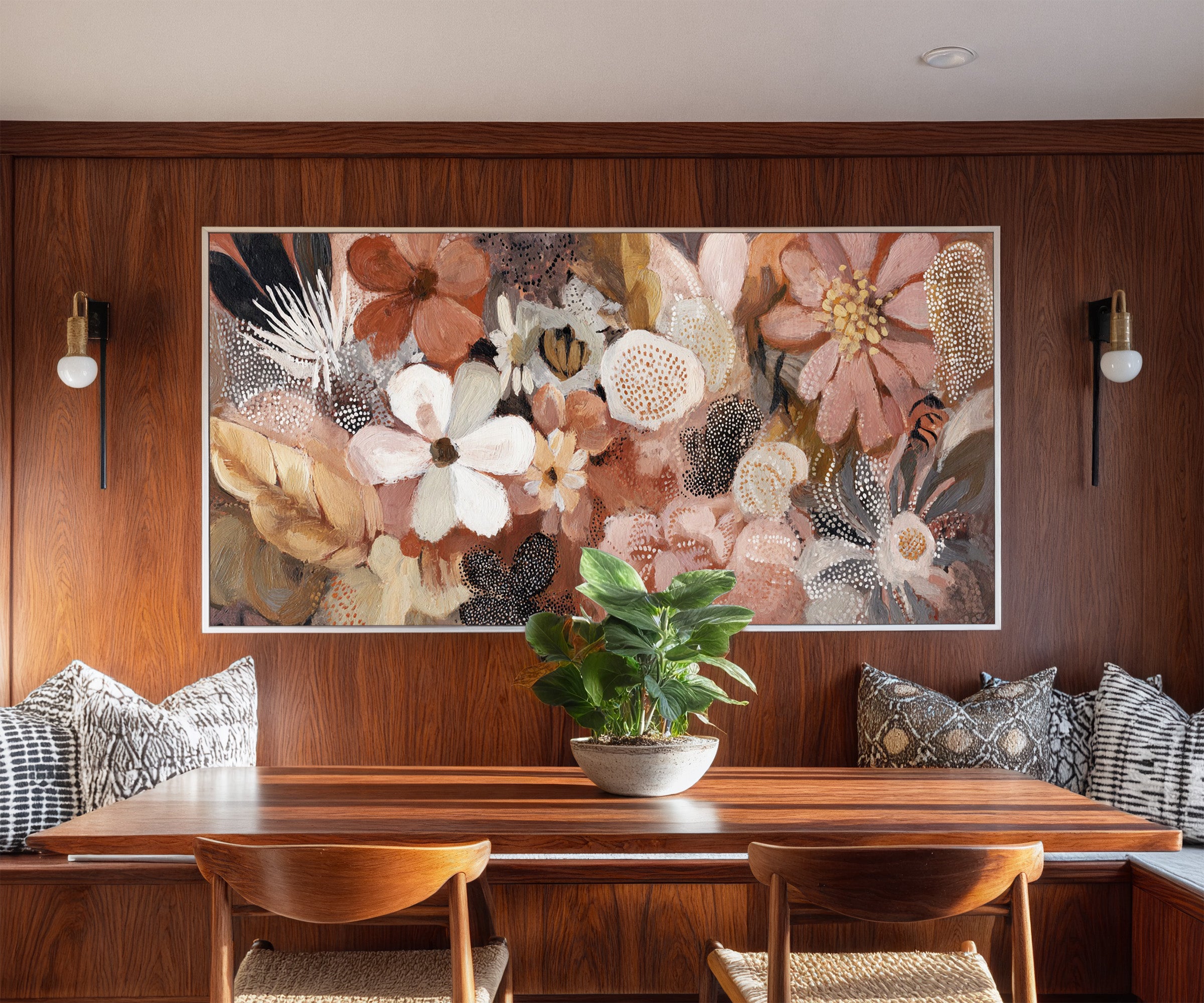 densely packed rounded flowers in blush, rust, canvas wall art in a white frame in a styled room setting