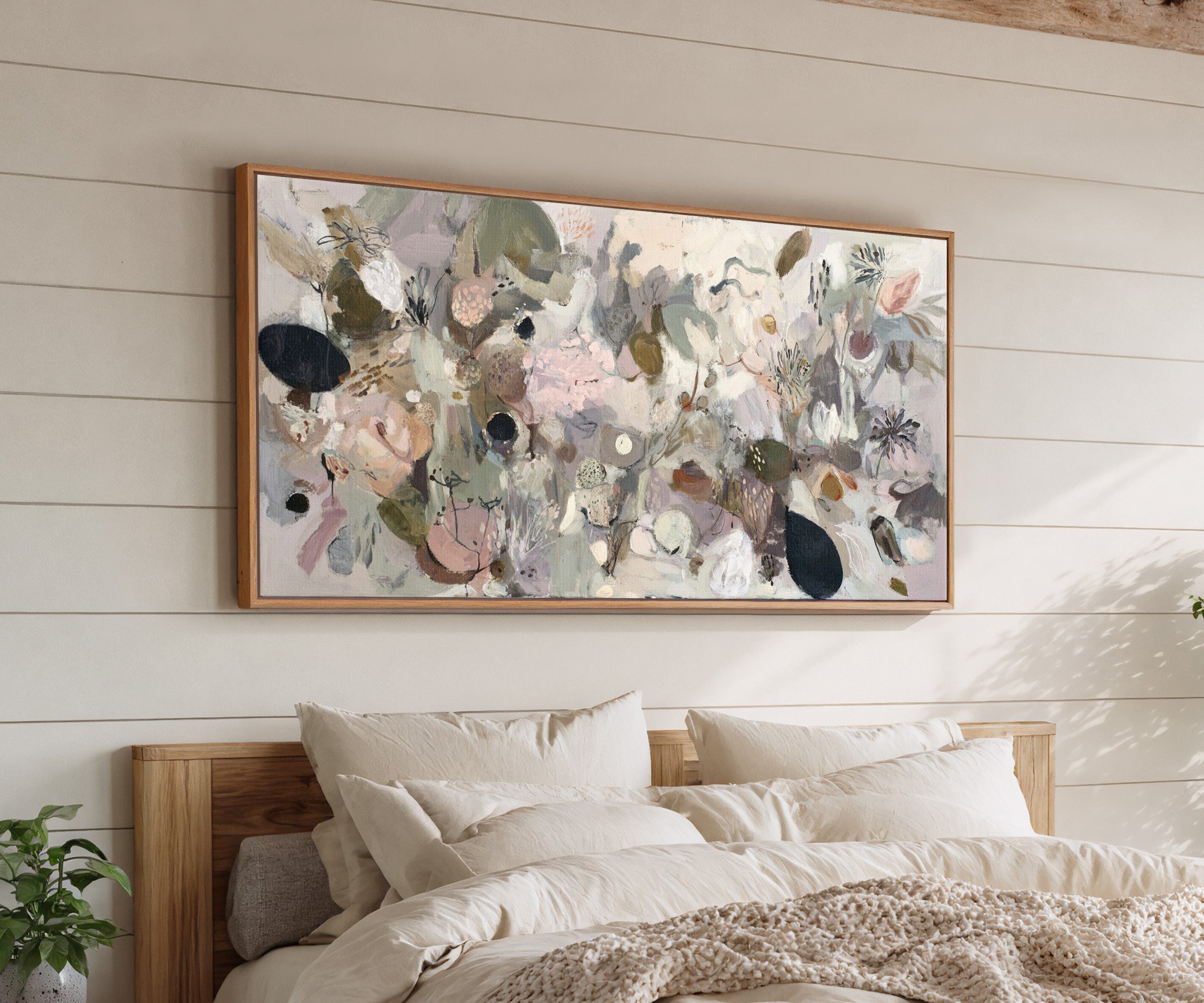 neutral abstract with moss green, taupe, beige, canvas wall art in an oak frame above a bed