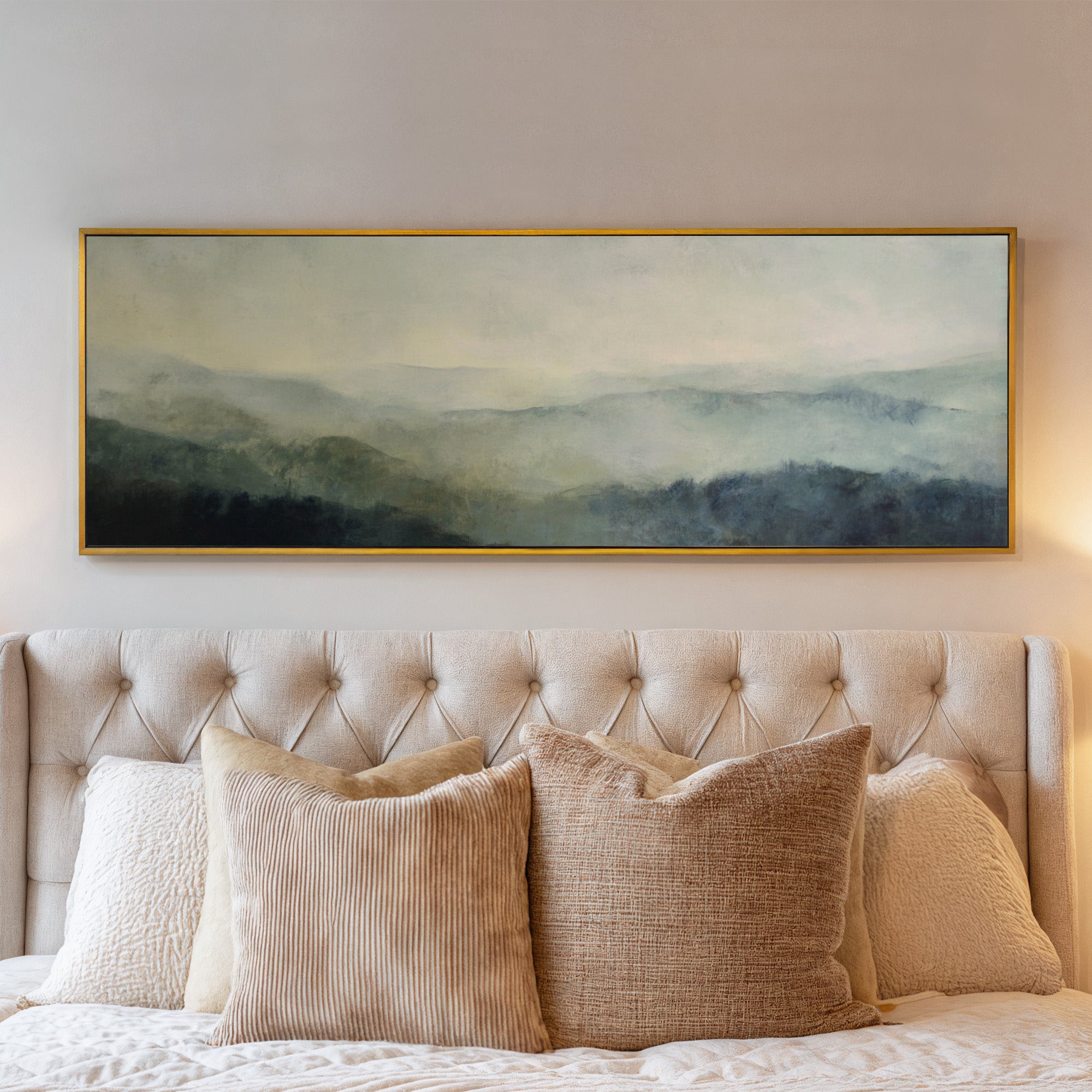 misty mountain ridges at dawn canvas wall art in a gold frame above a bed