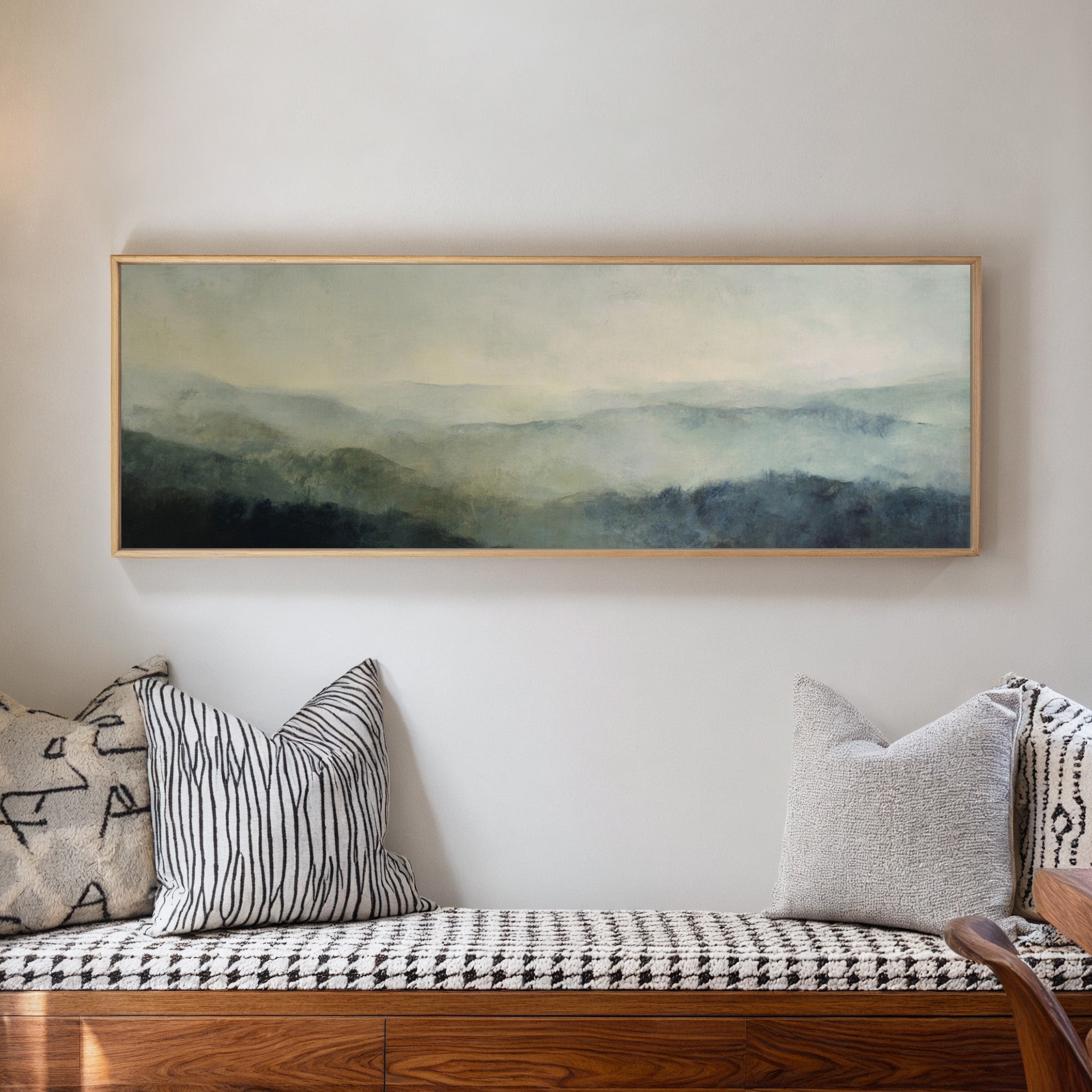 misty mountain ridges at dawn canvas wall art in a natural wood frame in a living room