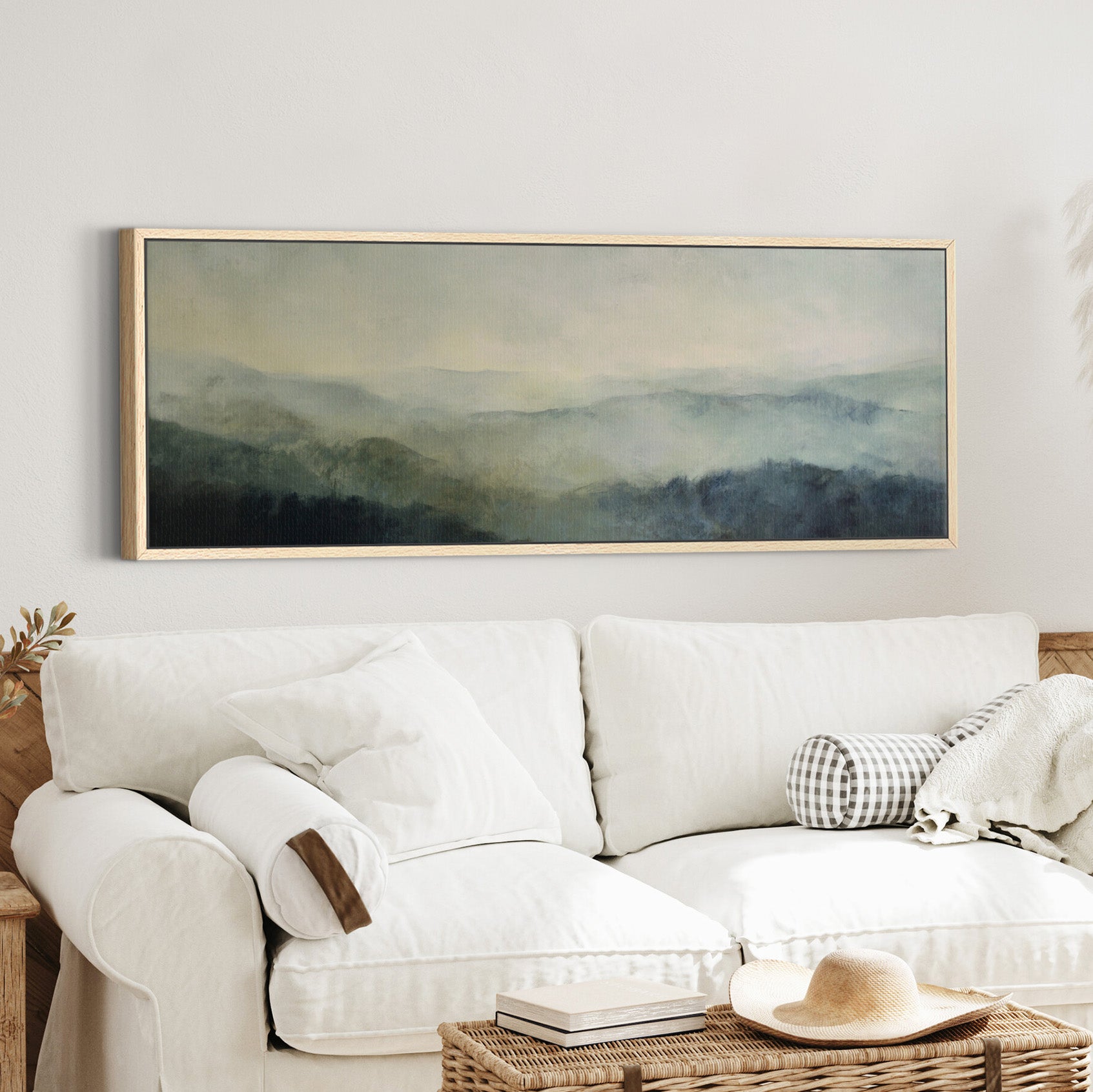 misty mountain ridges at dawn canvas wall art in an oak frame in a styled room setting