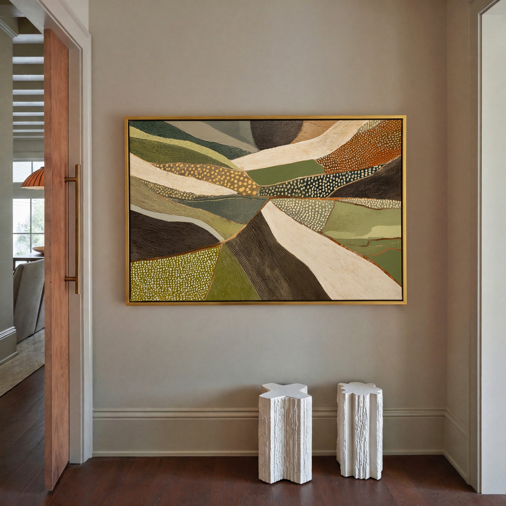 layered olive, cream, and brown abstract with canvas wall art in a gold frame in a styled room setting