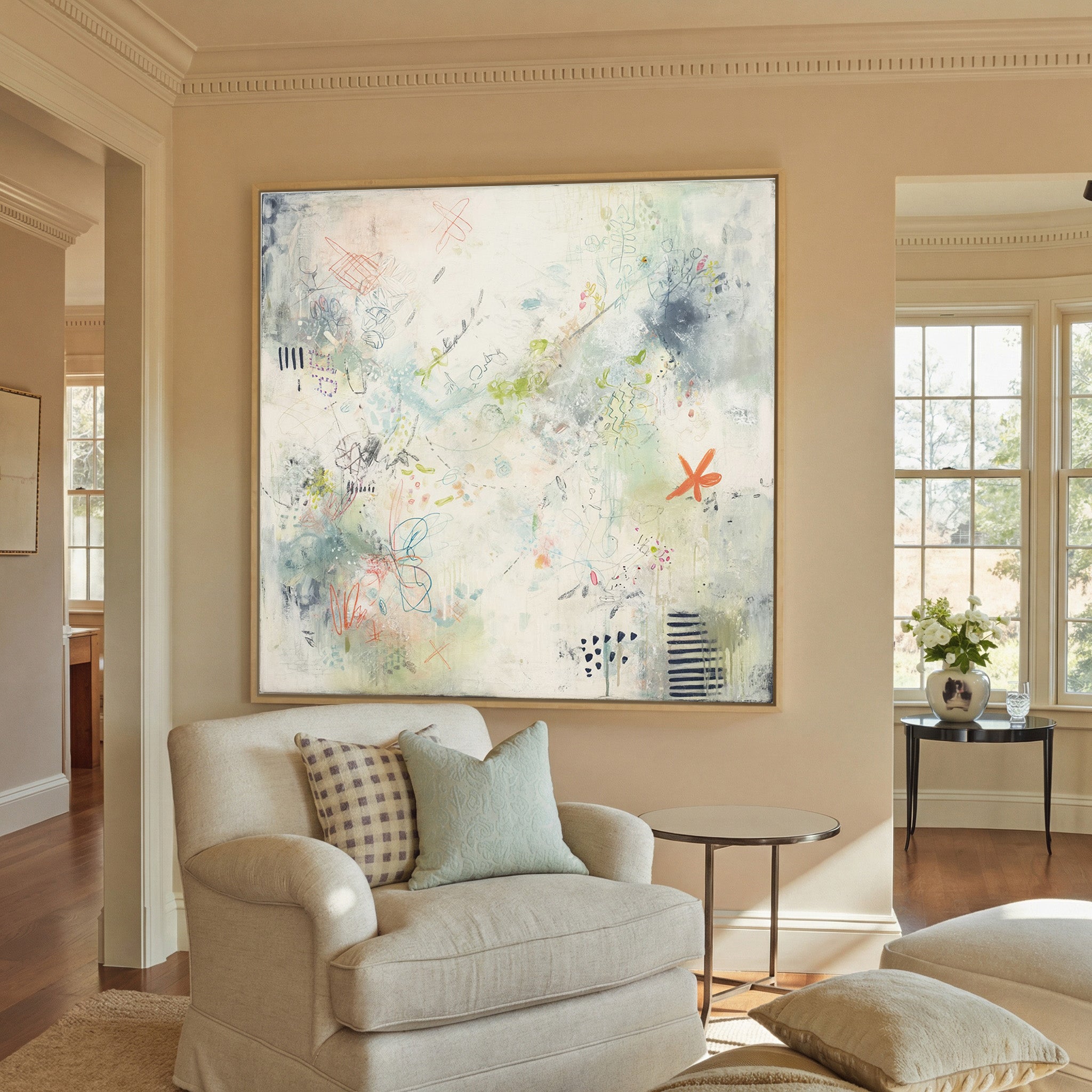 airy cream abstract with pastel doodles and canvas wall art in a natural wood frame in a styled room setting