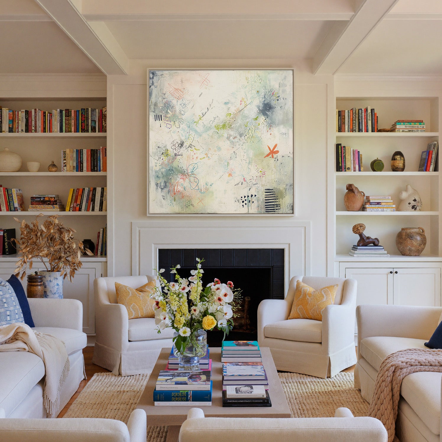 airy cream abstract with pastel doodles and canvas wall art in a white frame above a fireplace
