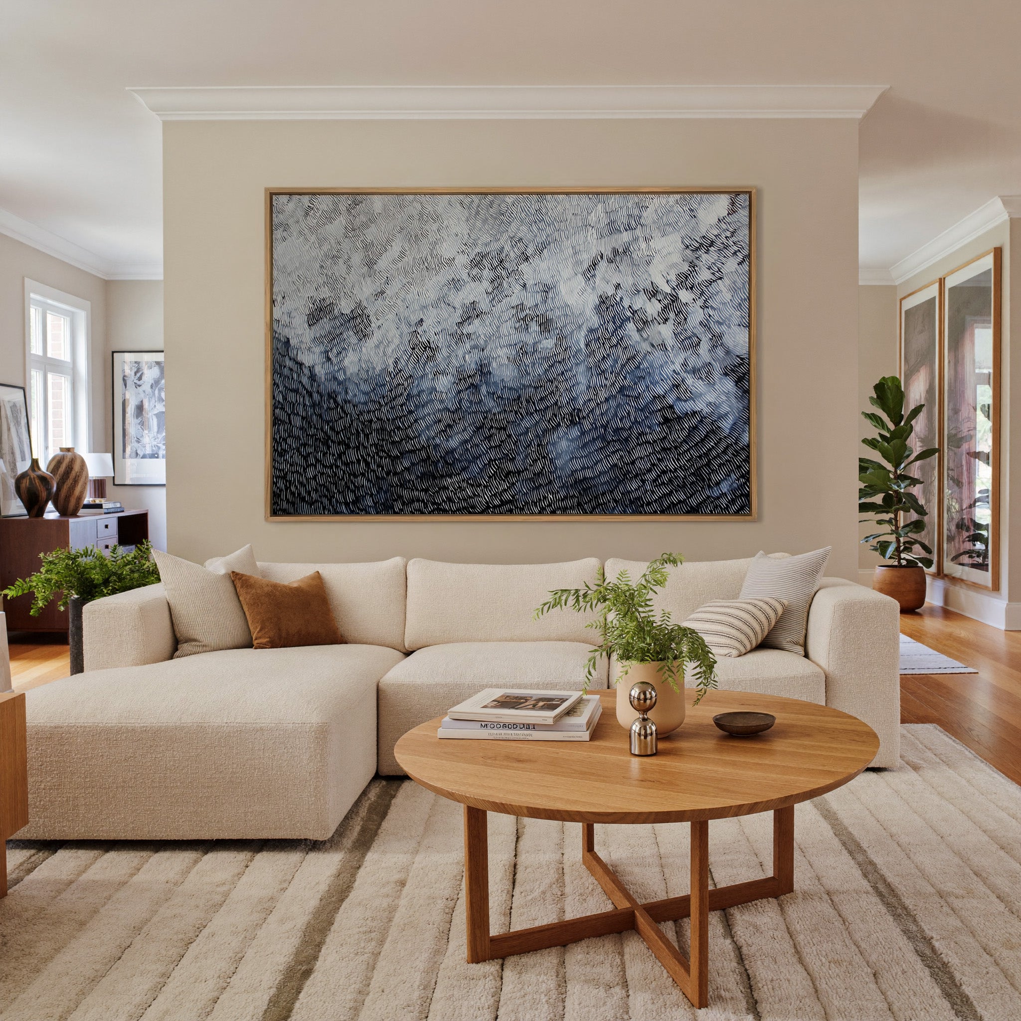 black and white abstract with dense curved canvas wall art in an oak frame in a living room