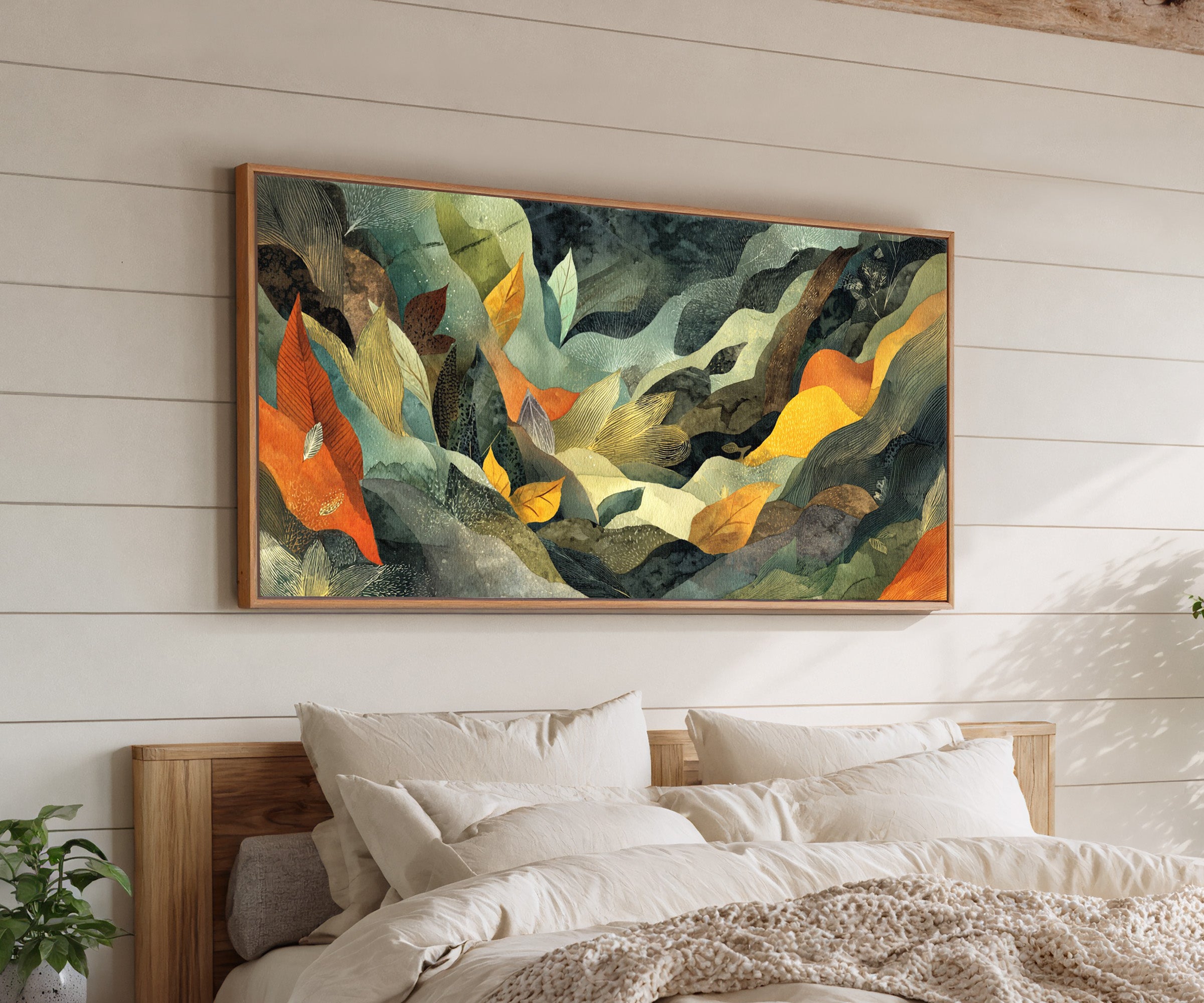 forest inspired abstract with layered leaf canvas wall art in an oak frame above a bed