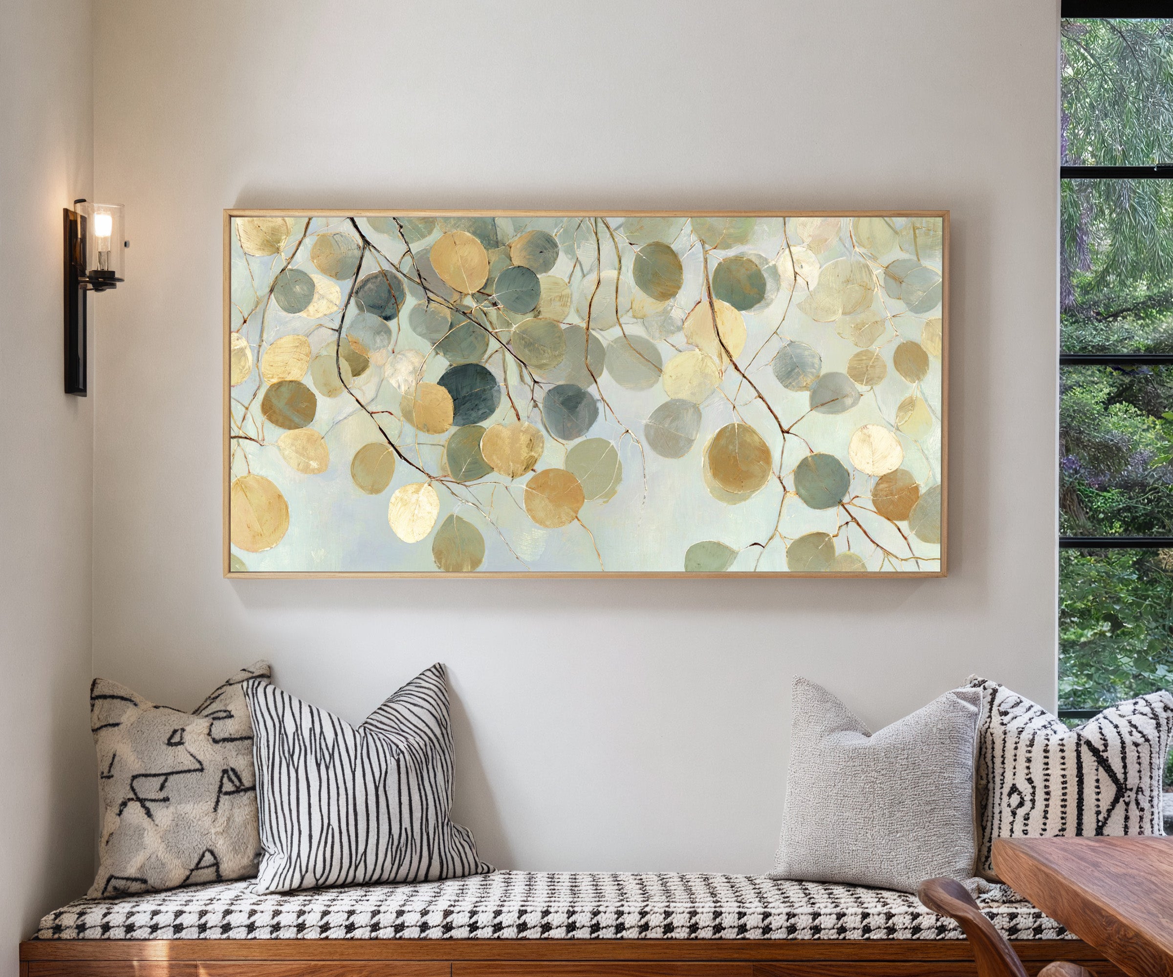 pale round leaves on branching stems canvas wall art in a natural wood frame in a living room
