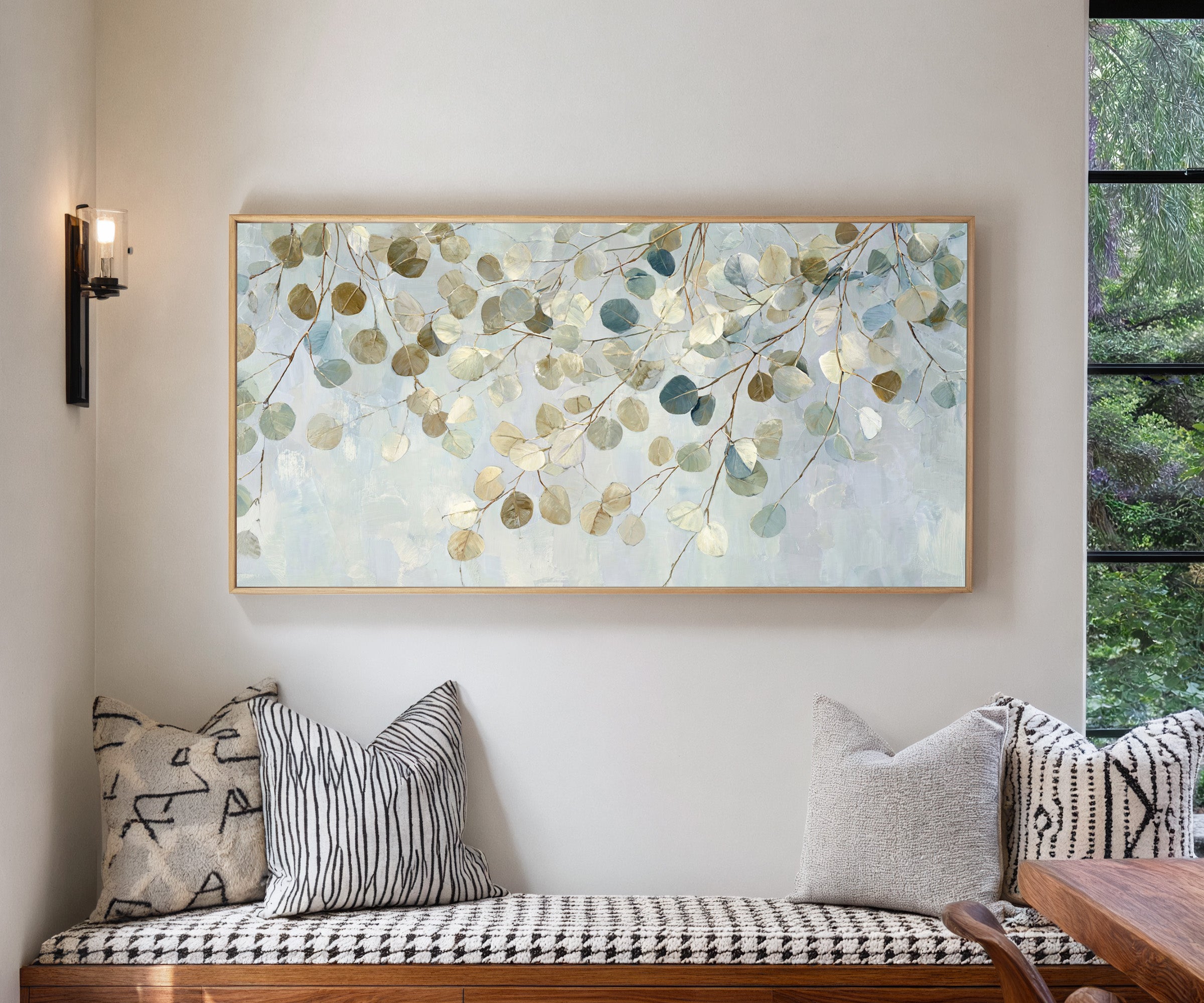 pale eucalyptus leaves on thin branching stems canvas wall art in a natural wood frame in a living room