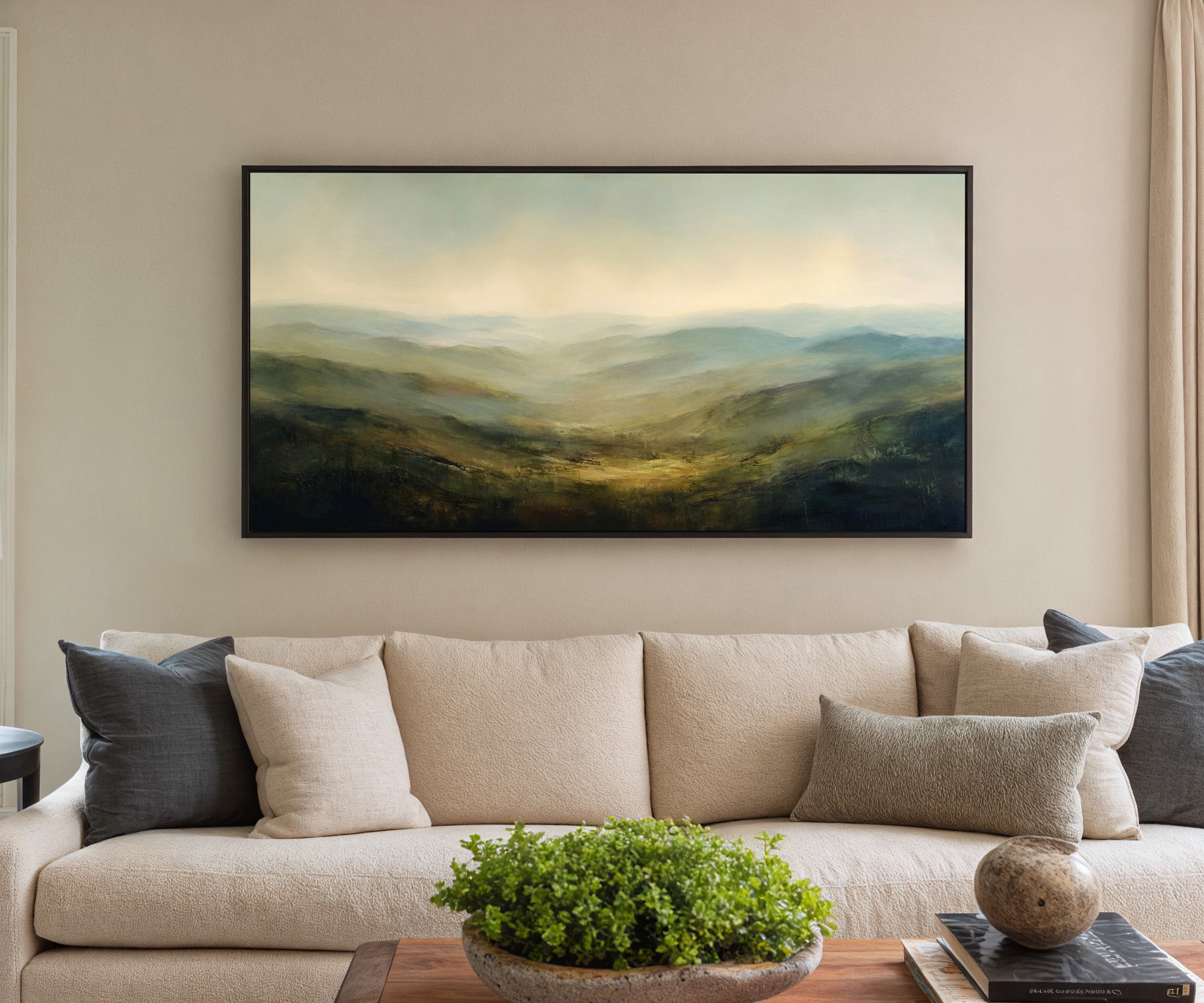 soft blue green ridgelines with a bright canvas wall art in a black frame in a styled room setting