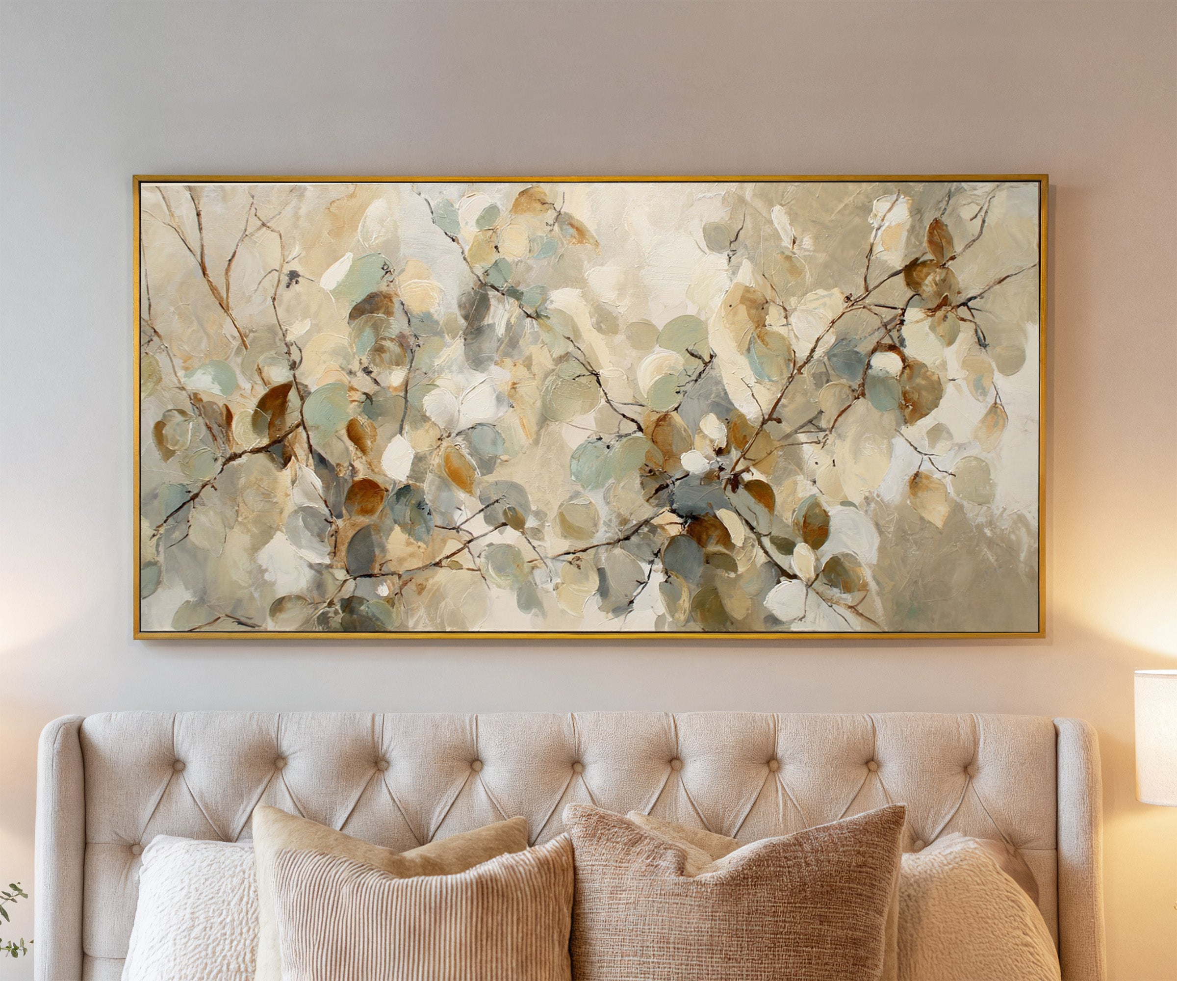 soft eucalyptus leaves in cream, sage, blue canvas wall art in a gold frame above a bed